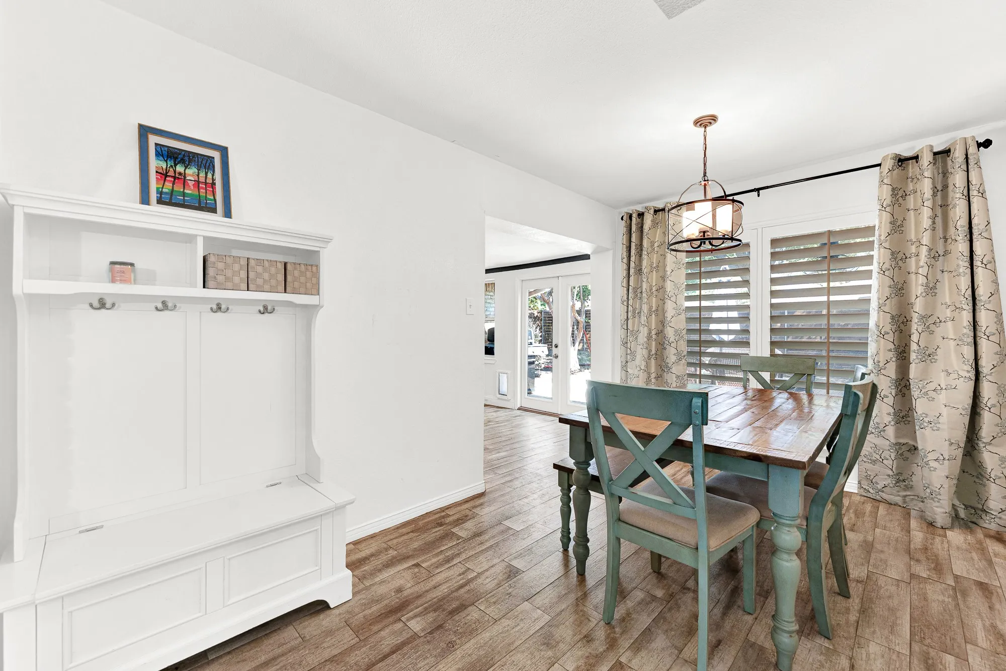 This angle captures the bright dining area with its generous window placement, cozy layout, and seamless connection to the adjacent patio entrance. You will love how easily this layout accommodates everyday meals and effortless indoor-outdoor entertaining.