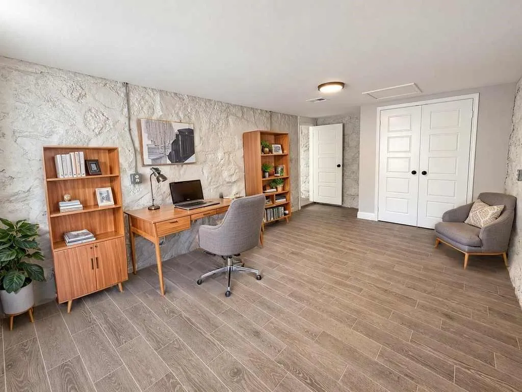 Laundry room depicted with virtual office furnishings; laundry connections are not clearly shown.
