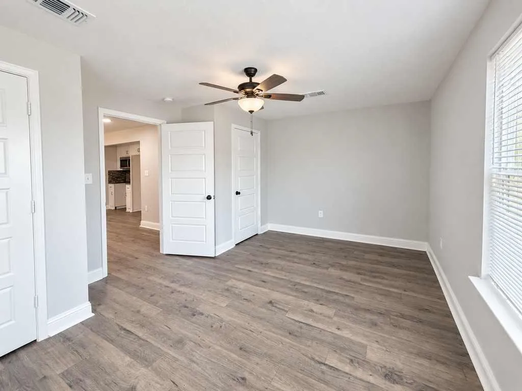Unfurnished main home bedroom showing its layout and doorway.