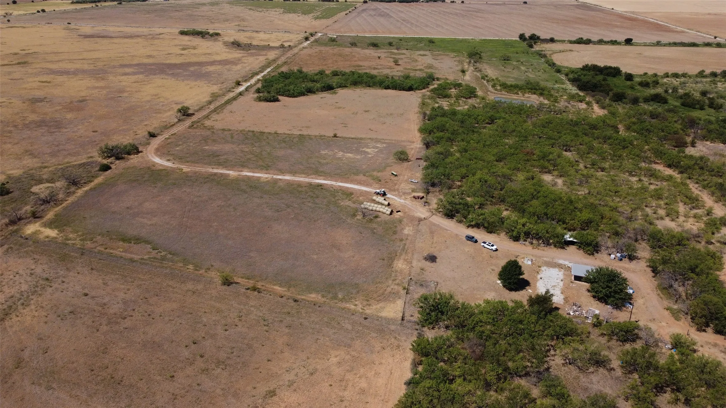 Expansive acreage featuring established vegetation and a dirt road network