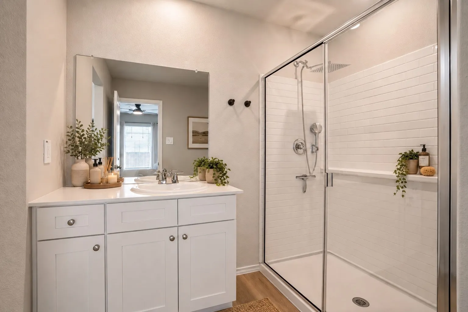 White vanity with a single basin sink, chrome faucet, and expansive mirror