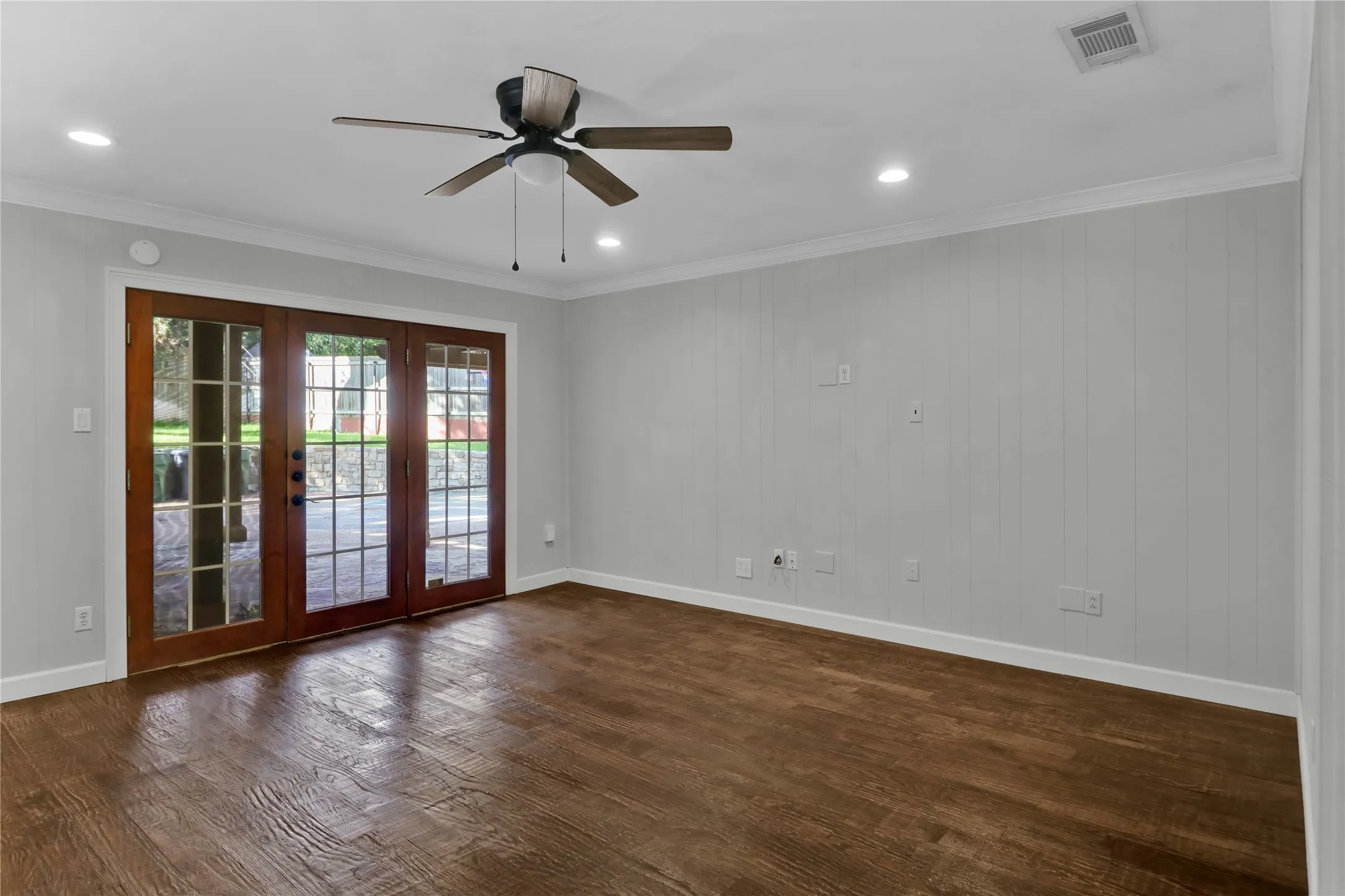 Family room leading to patio an basketball goal.