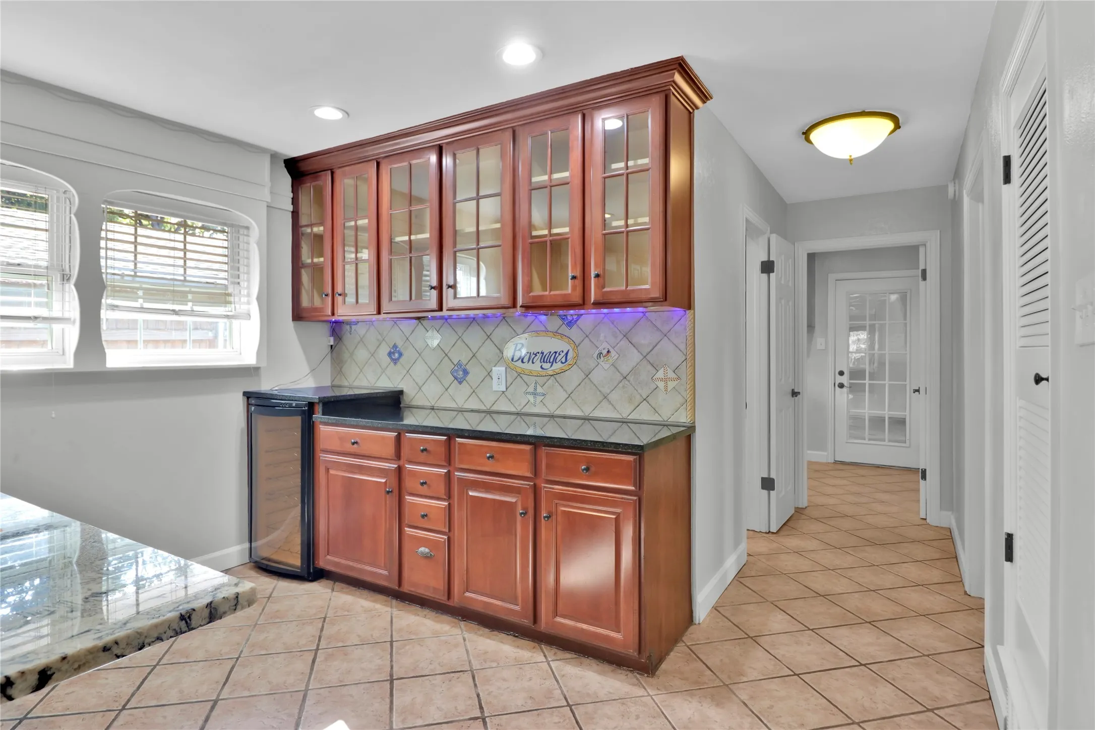 Breakfast area leading to 4th bedroom, bathroom, laundry, and garage.