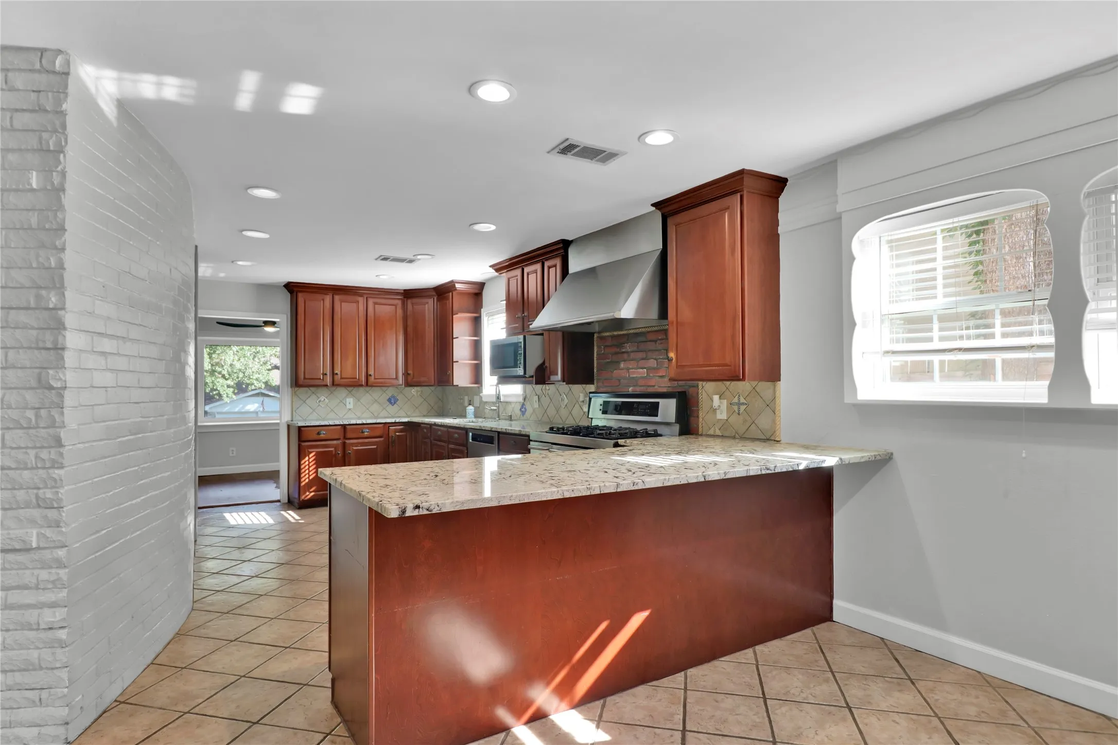 Kitchen flows from breakfast area to cooking area to dining room.