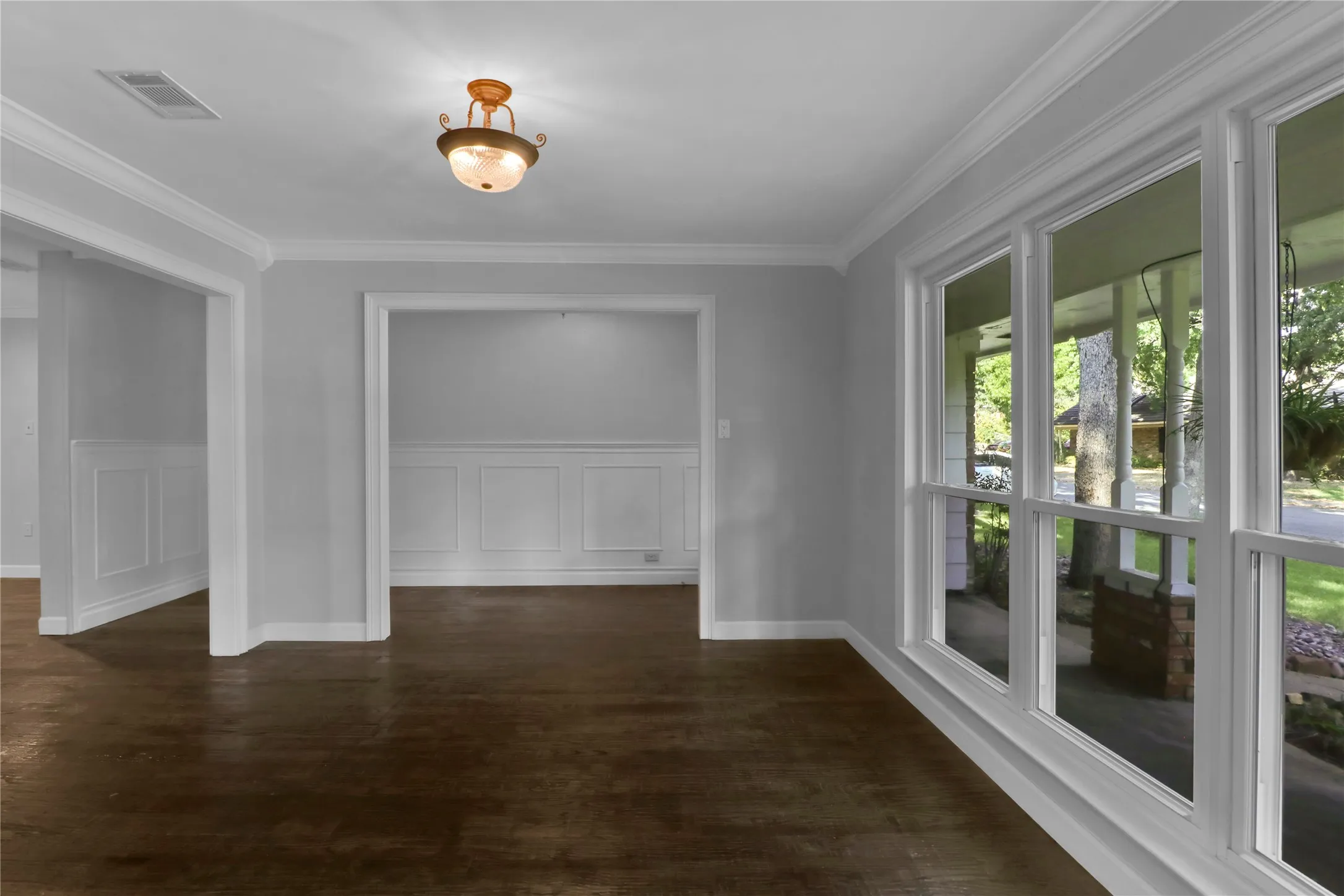 Formal living room overlooks front yard and porch.