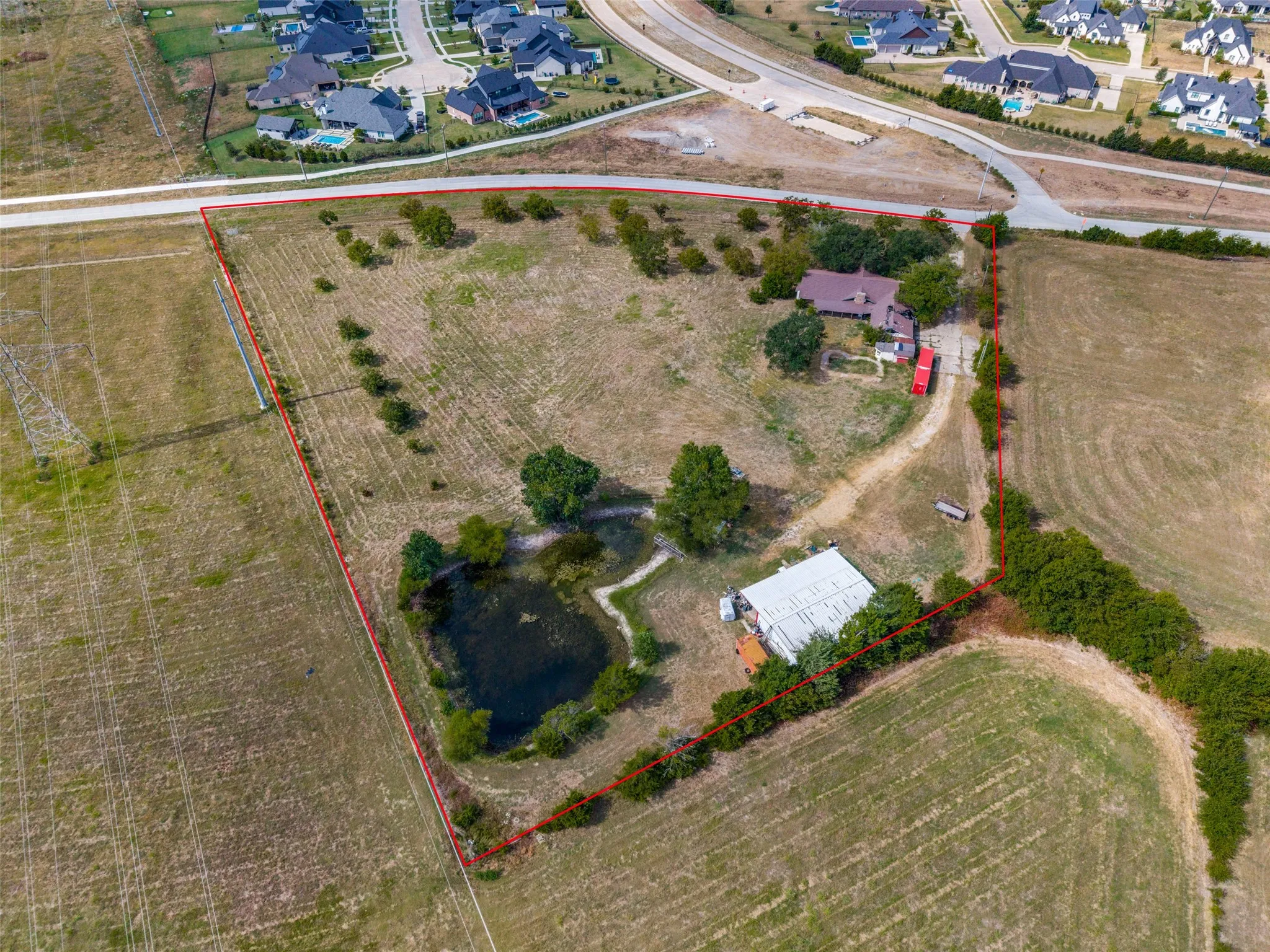 Expansive lot with established trees and a natural pond