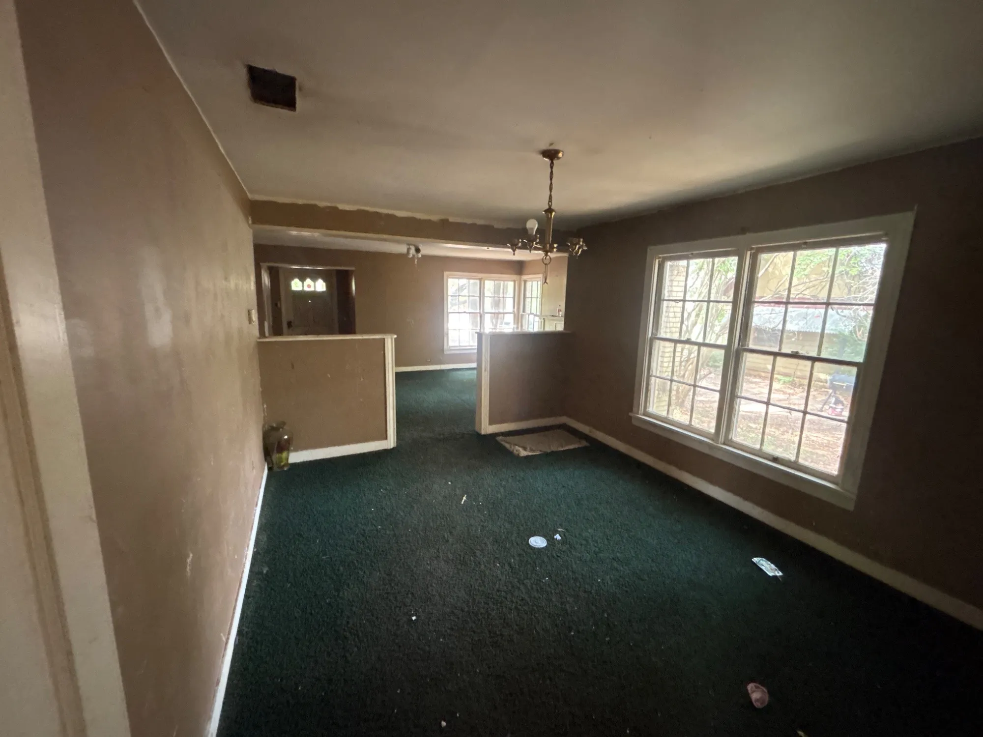Dining area transition space highlighted by multi-pane windows and broad layout flow.