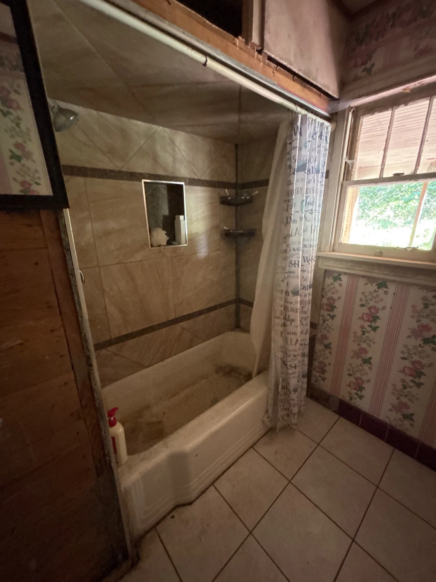 En-suite bath space featuring a step-in shower stall and wood panel wall accents.