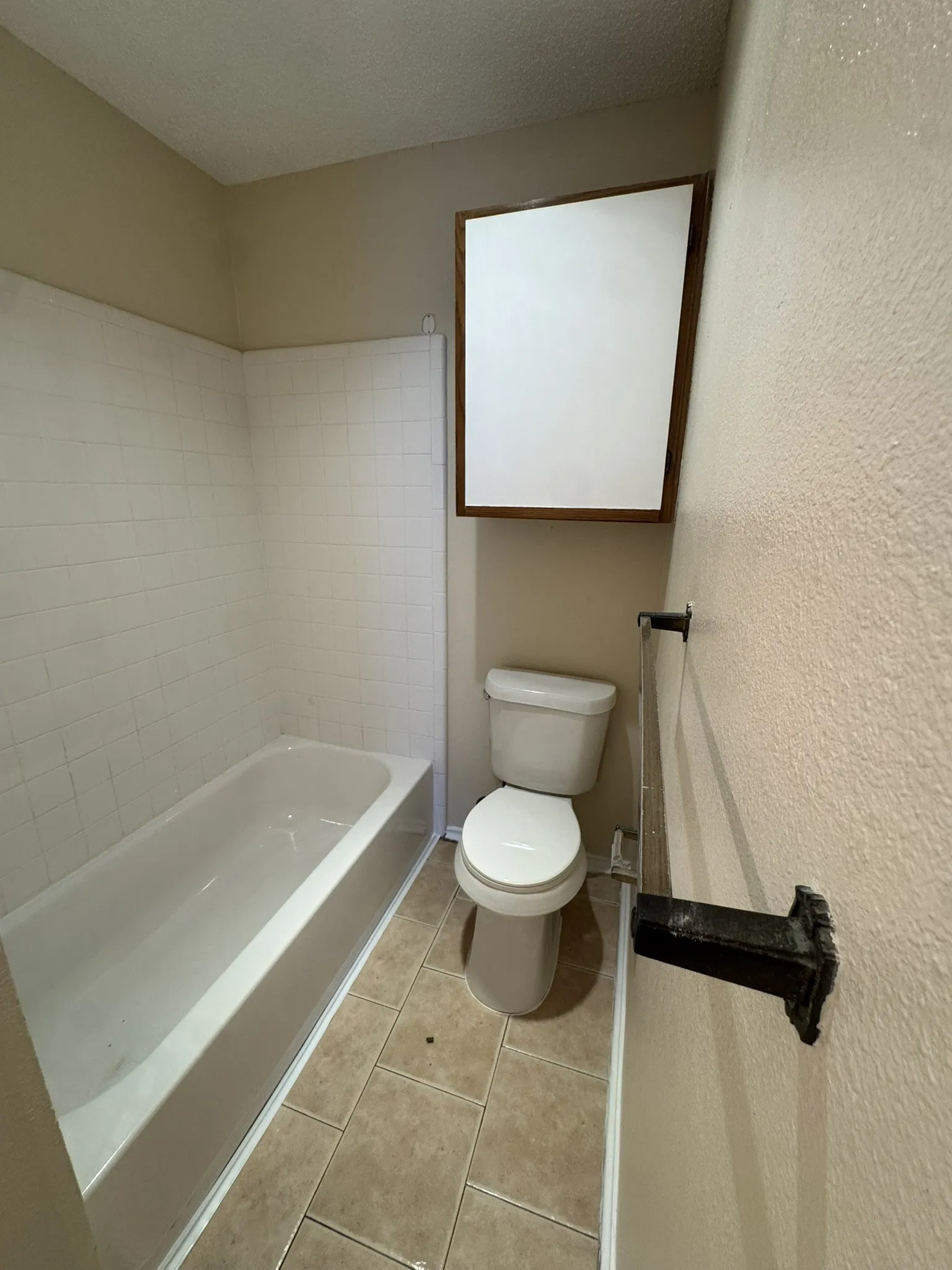 White subway tile shower surround with a built-in tub