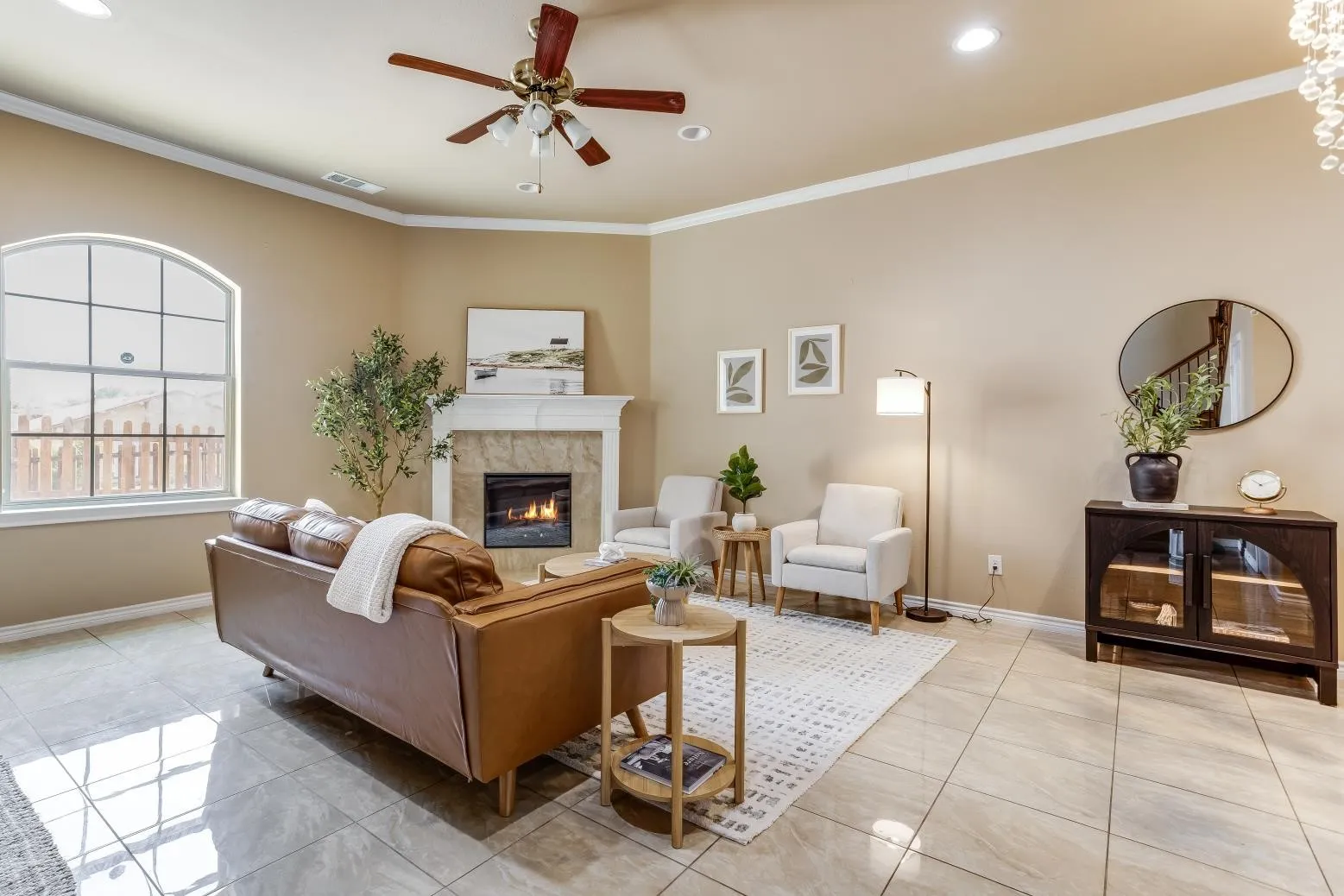 Tiled flooring, arched window, fireplace with mantel, recessed lighting, and ceiling fan