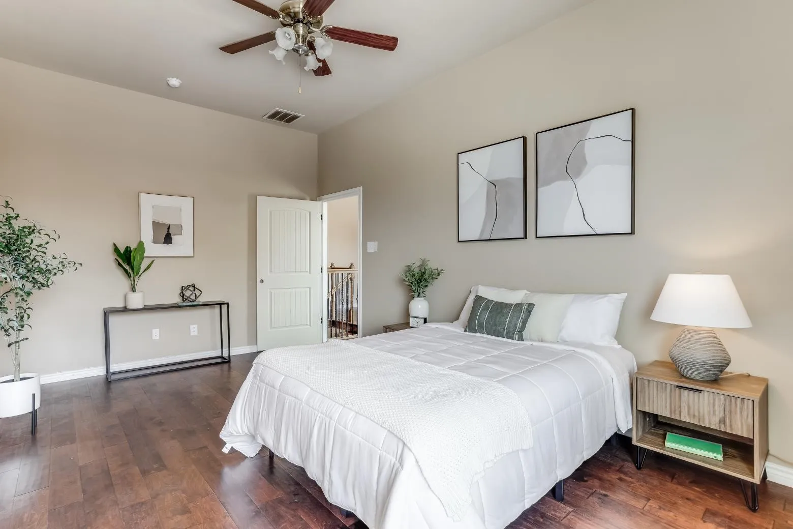 Wood-finish flooring, ceiling fan with light fixture, and neutral wall tones