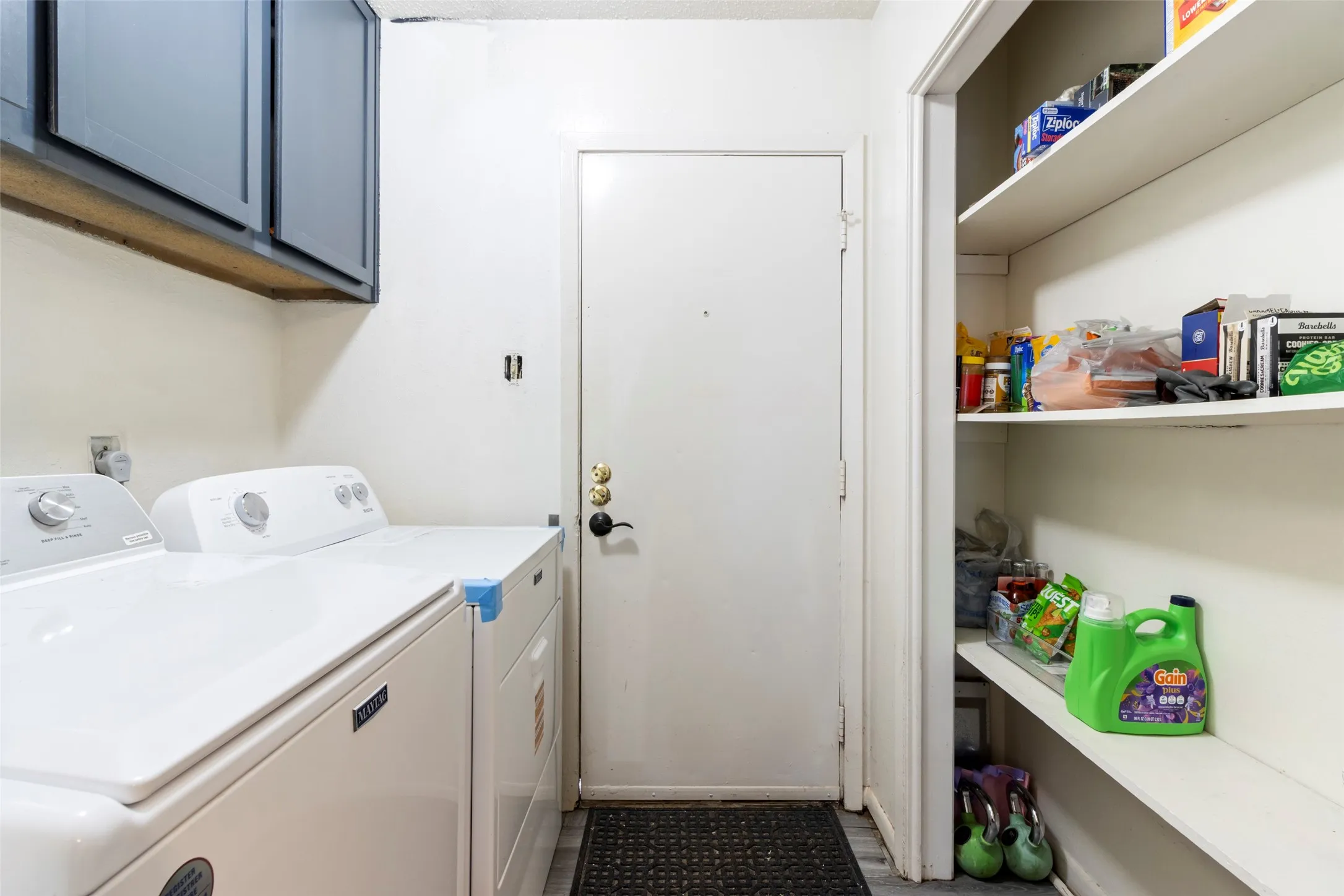 Built-in cabinetry and open shelving provide ample storage