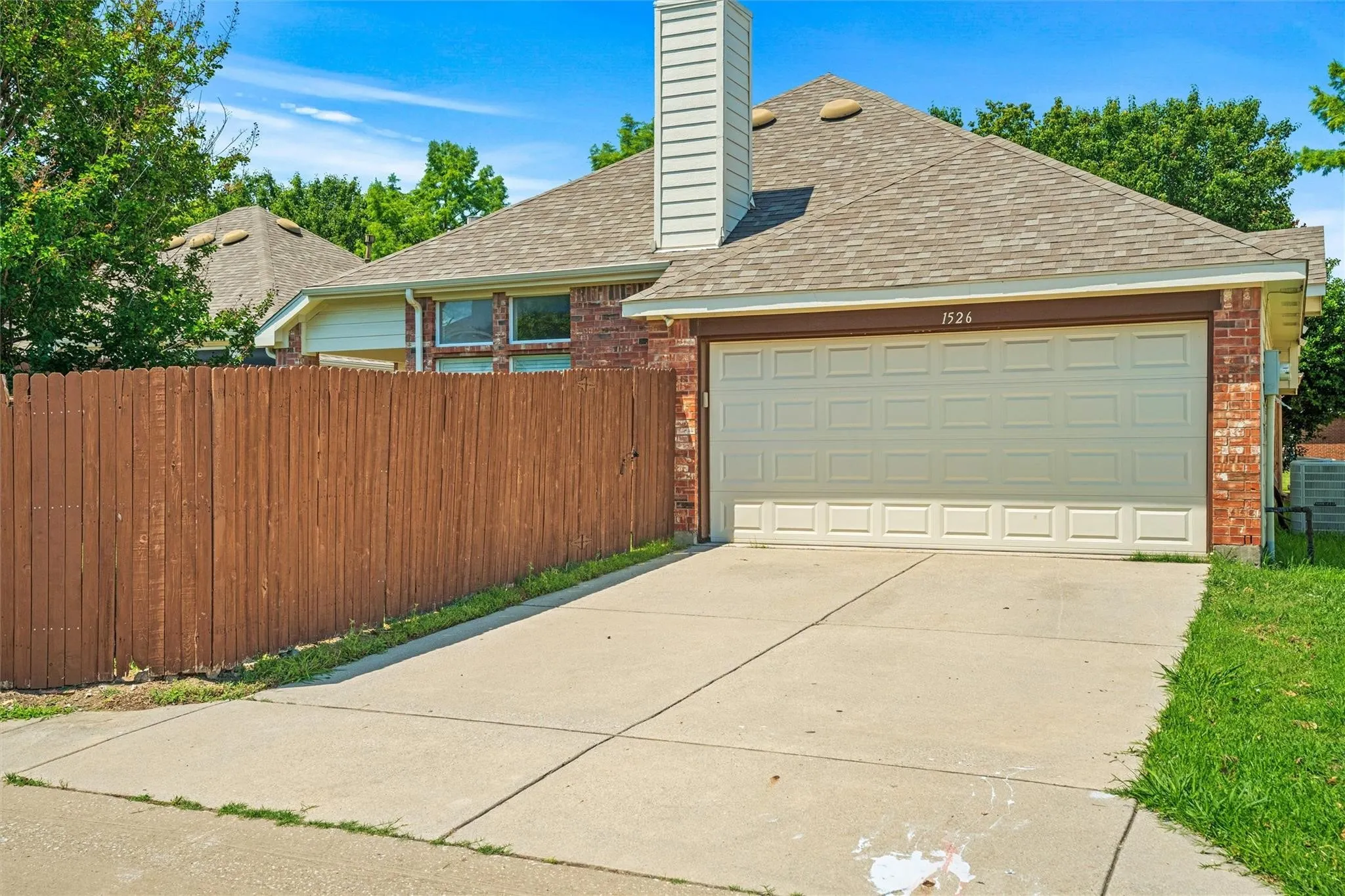 Brick exterior with a paneled garage door