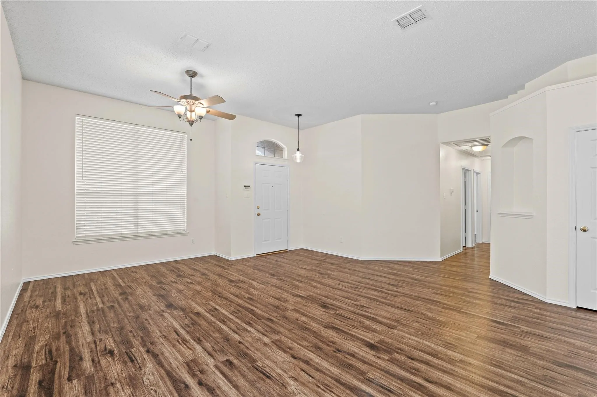 Wood-finish flooring throughout, paired with light-colored walls