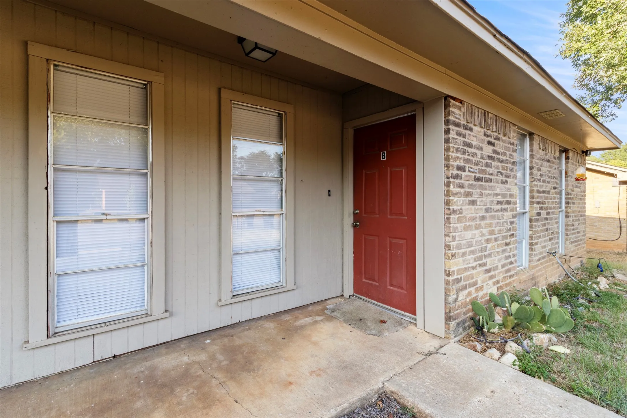 Brick exterior with a covered entry