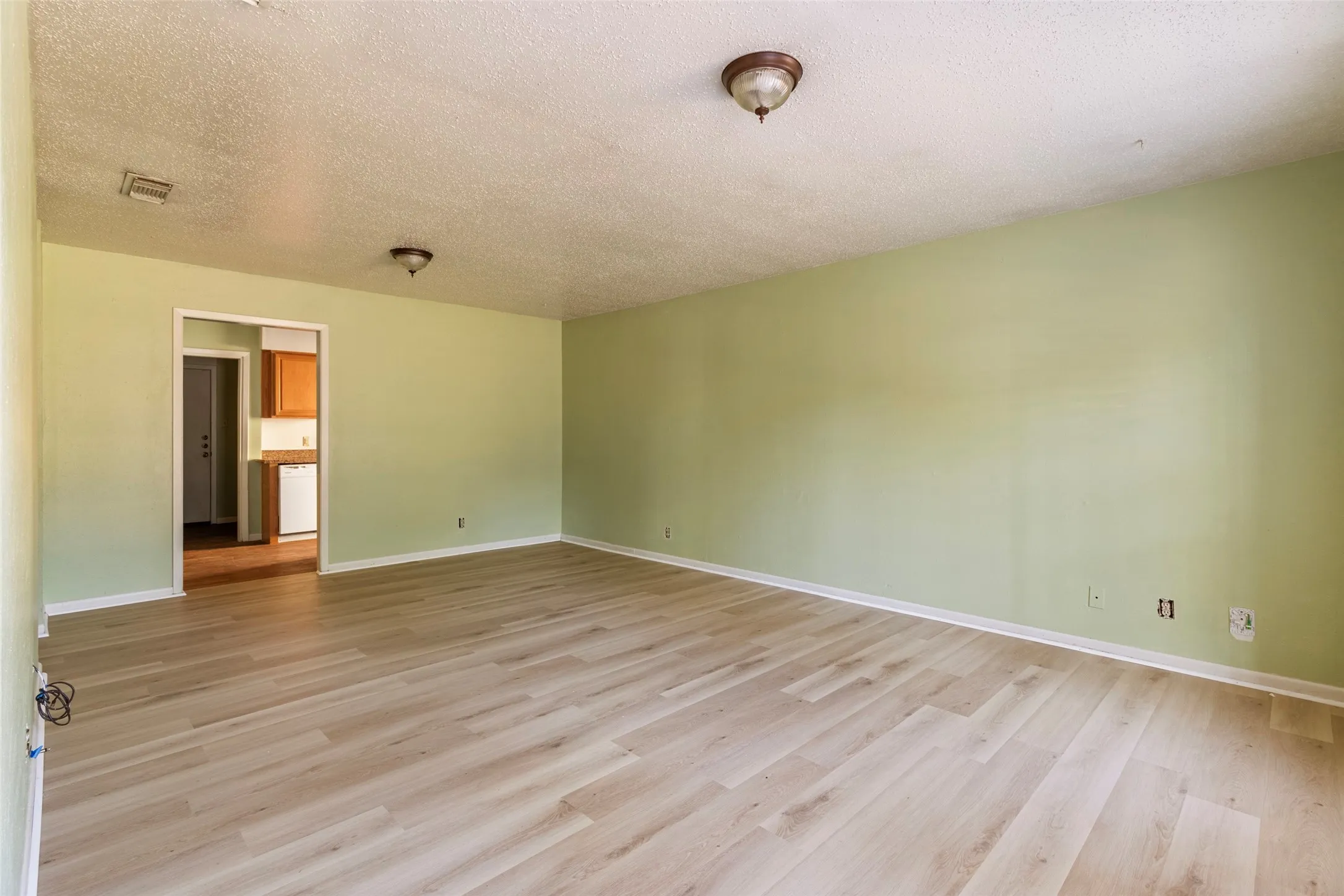 Light wood-finish flooring with white trim