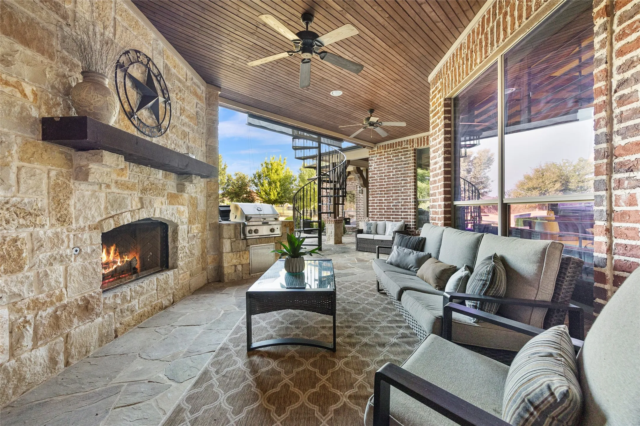 Cozy fireplace and attached grill on covered back patio