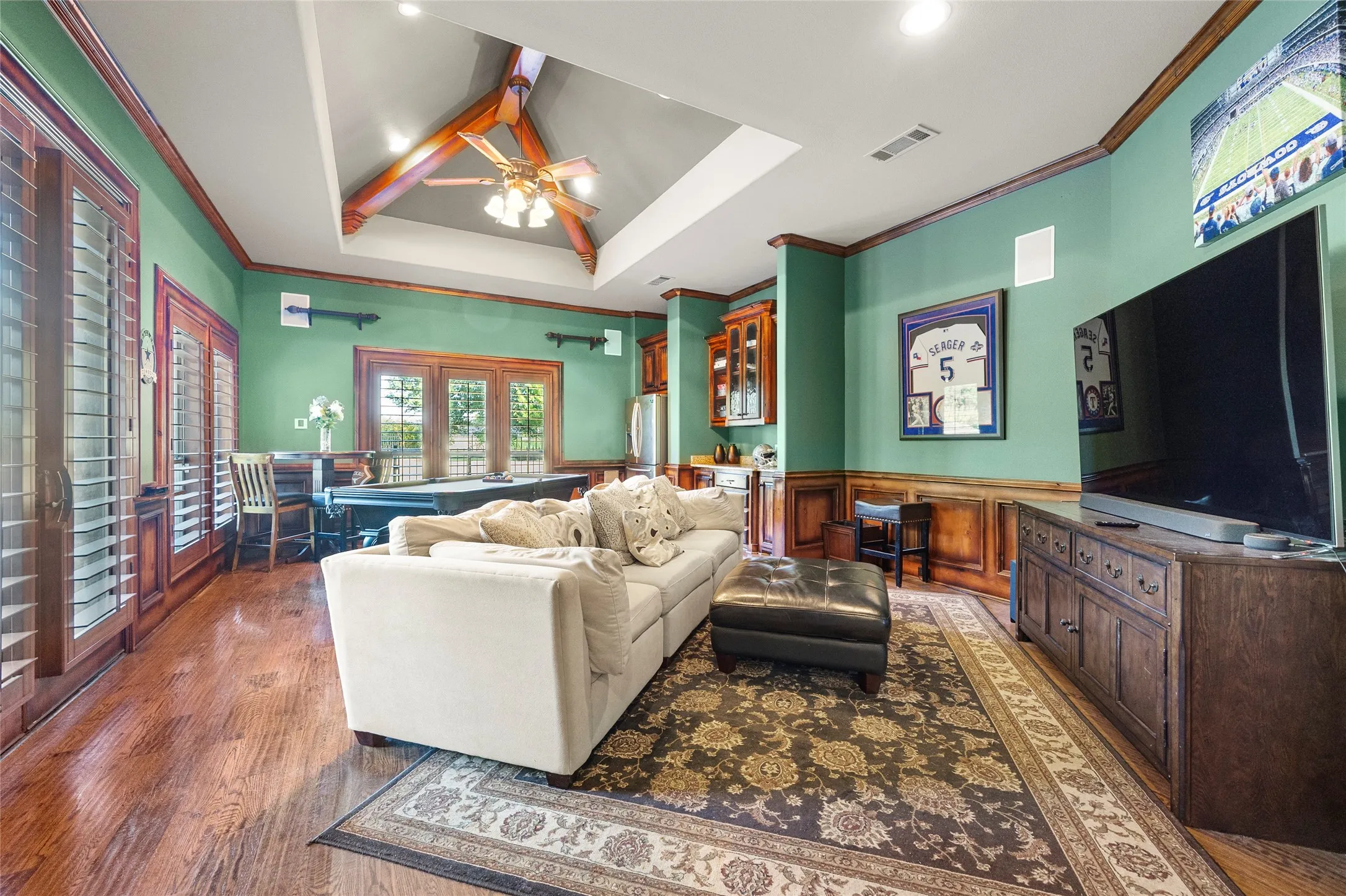 Large Downstairs entertainment room with doors that open to patio. Pool table included!