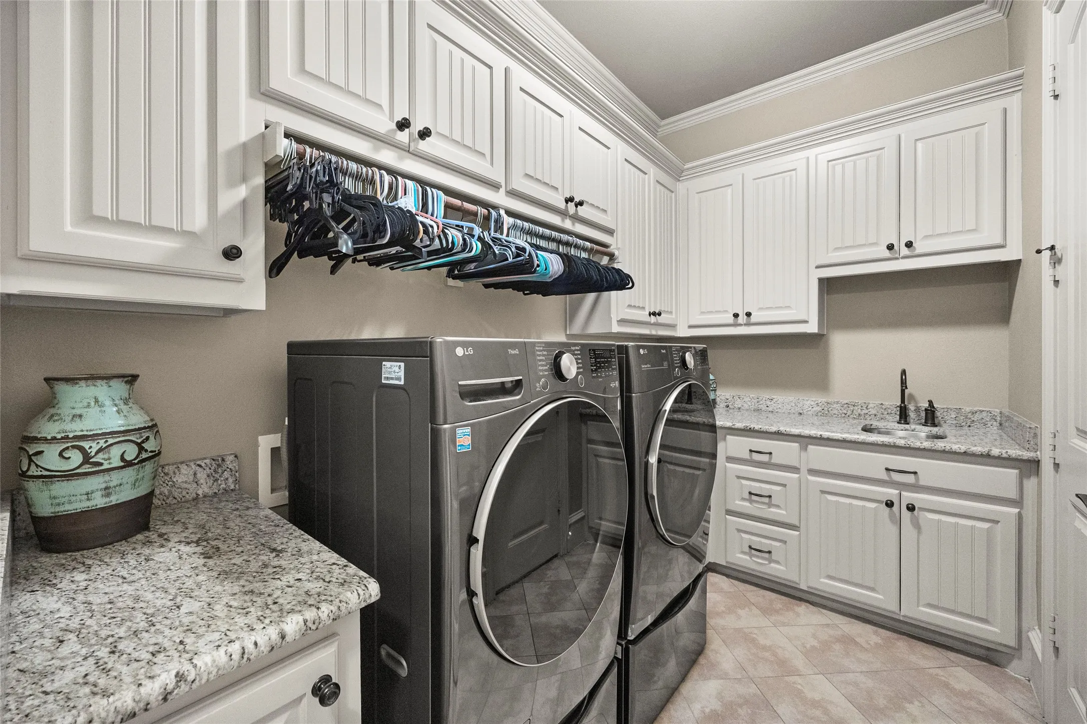Plenty of cabinet space, a sink and a hanging rod. Door to primary bedroom closet for quick access!
