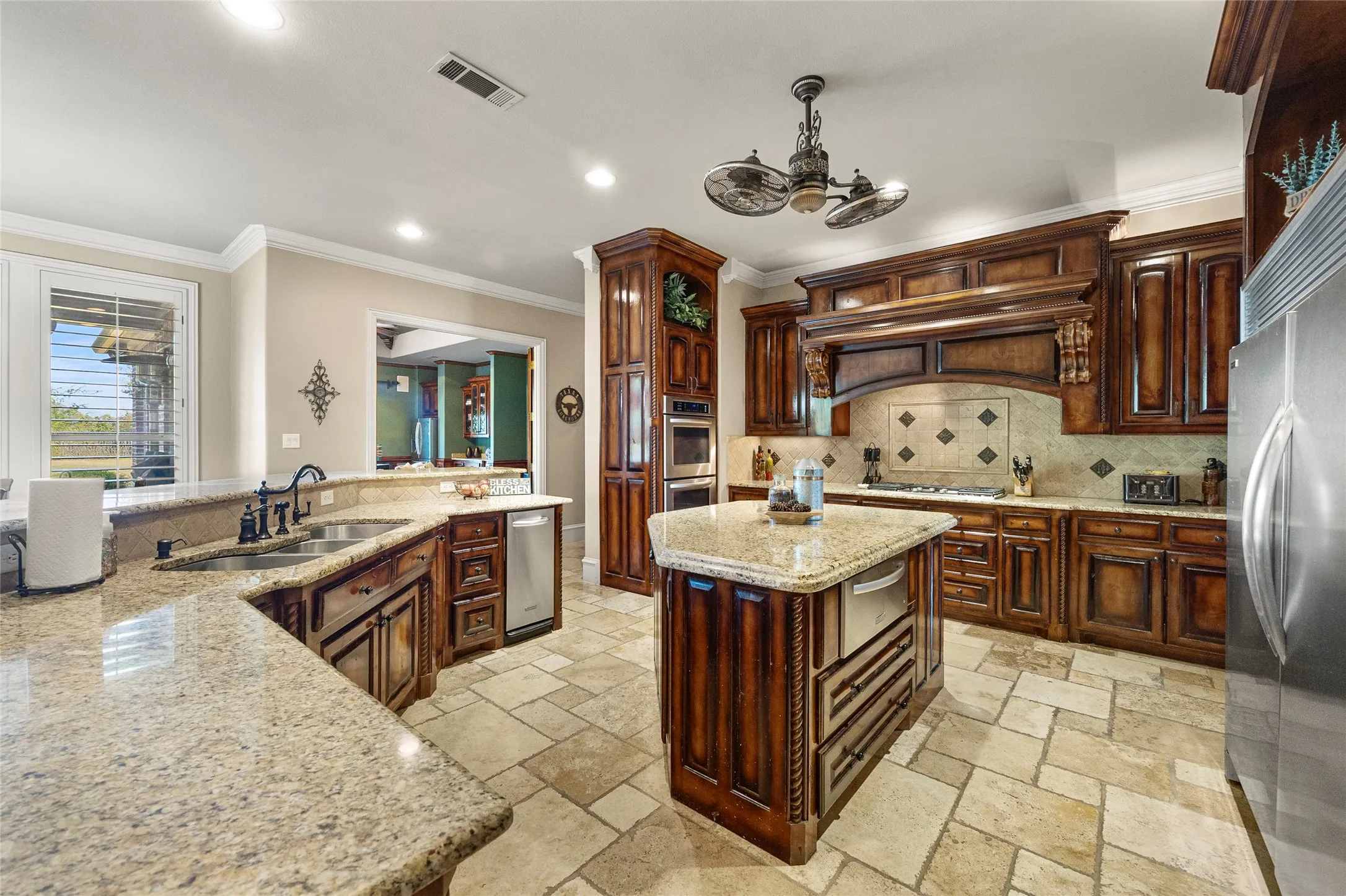 Richly stained cabinets, island and gas cooktop