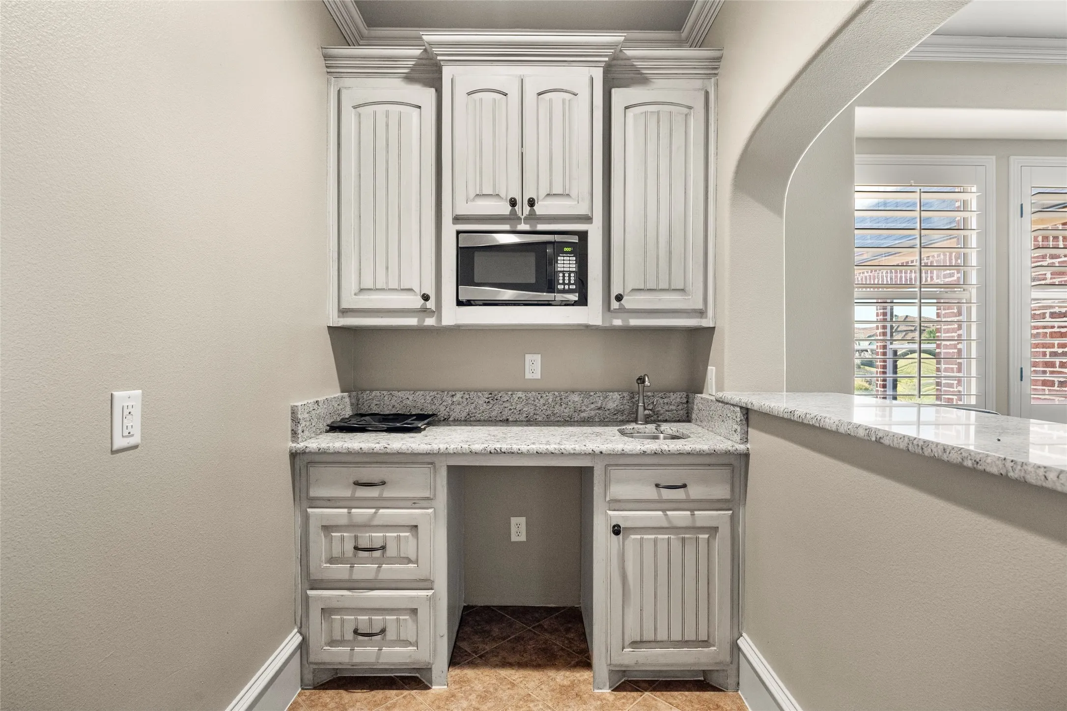 Wet bar with place for mini-fridge in upstairs family room
