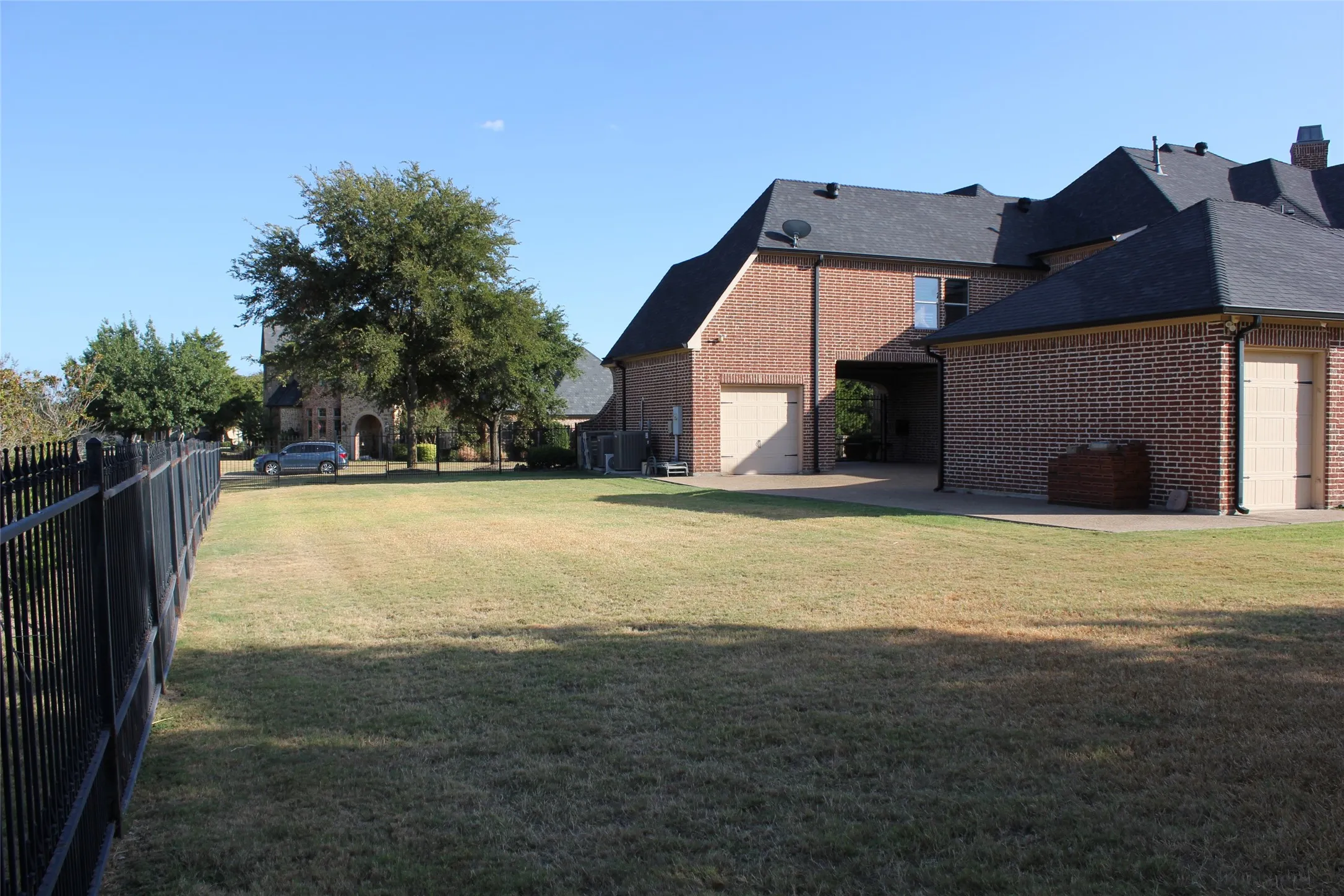 Side yard and extra parking space by garage