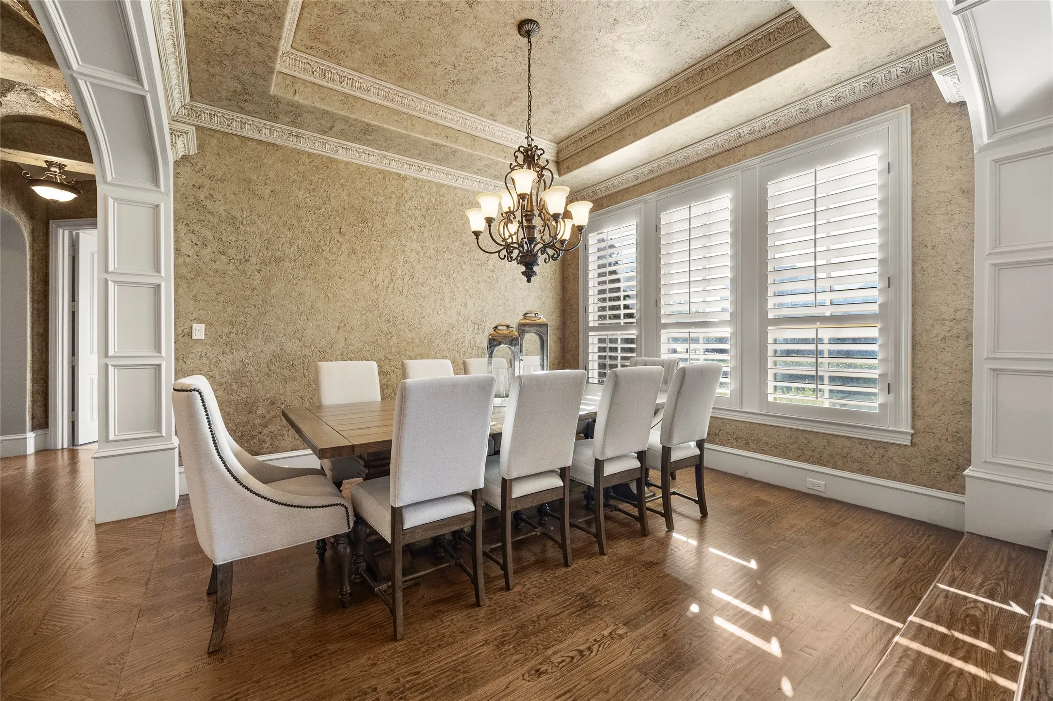 Dining with tray ceiling and a chandelier that makes a statement