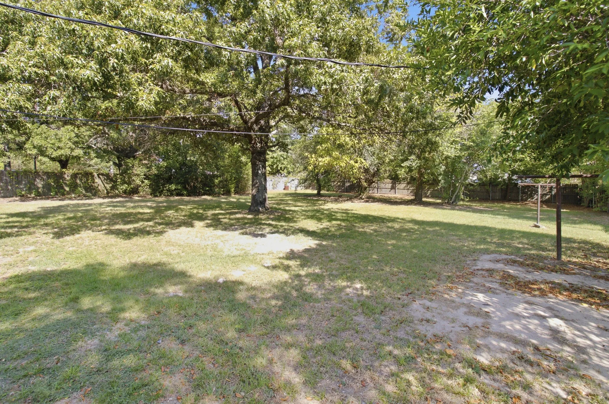 Expansive lawn with mature trees providing ample shade