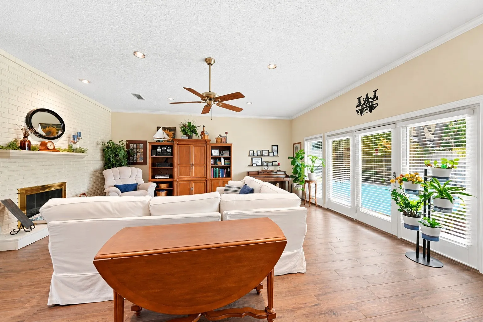 Wood-finish flooring throughout, vaulted ceiling, and recessed lighting