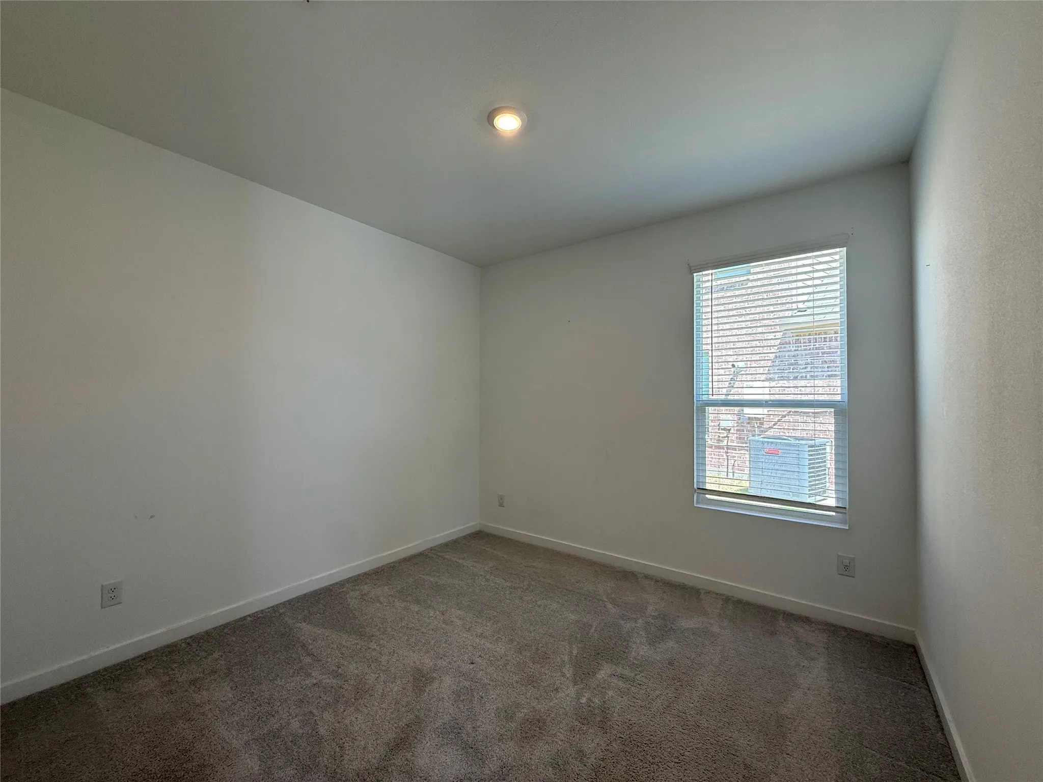 Carpeted flooring, recessed ceiling lighting, single window with blinds