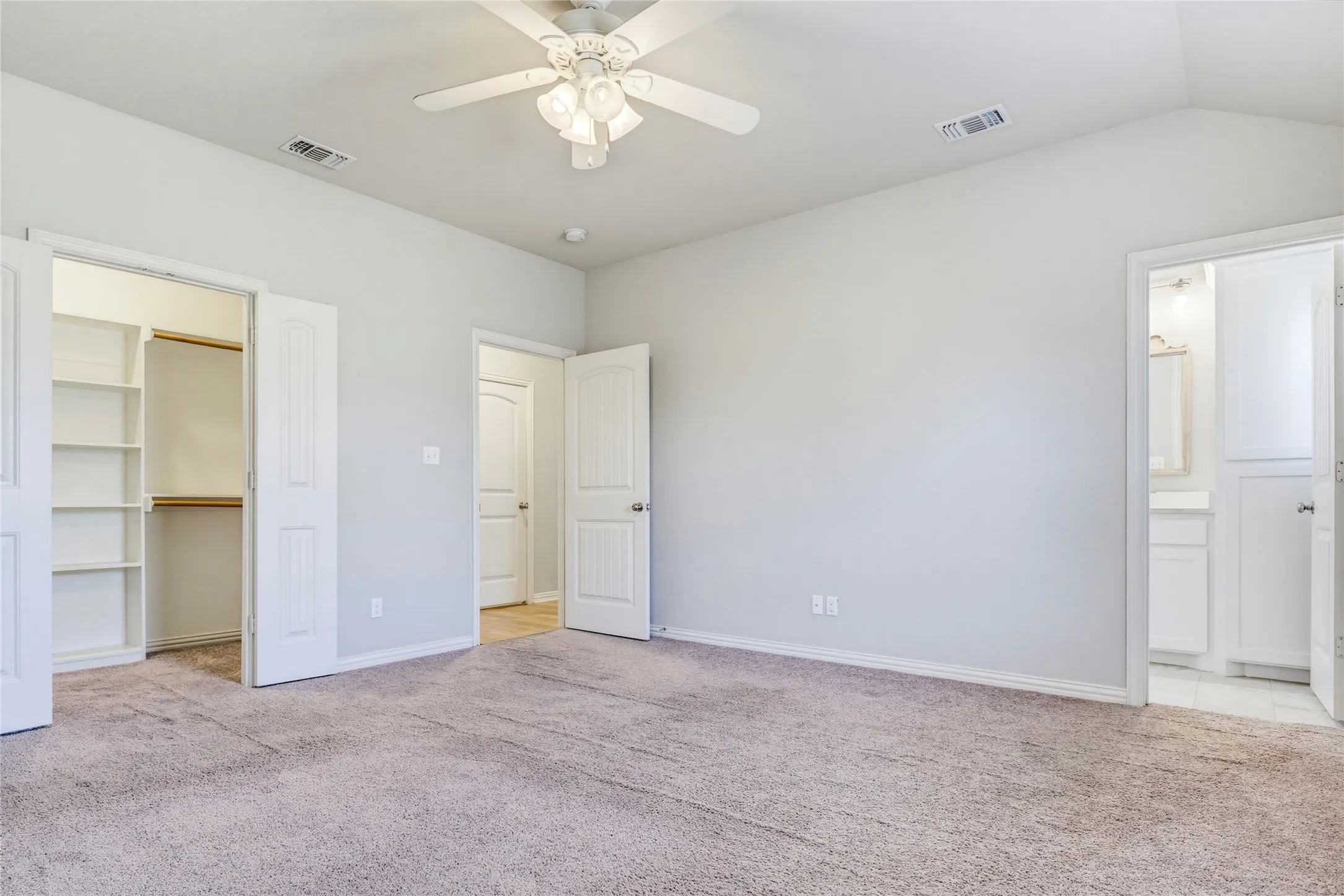 Carpeted room featuring a ceiling fan, vaulted ceiling, and recessed lighting