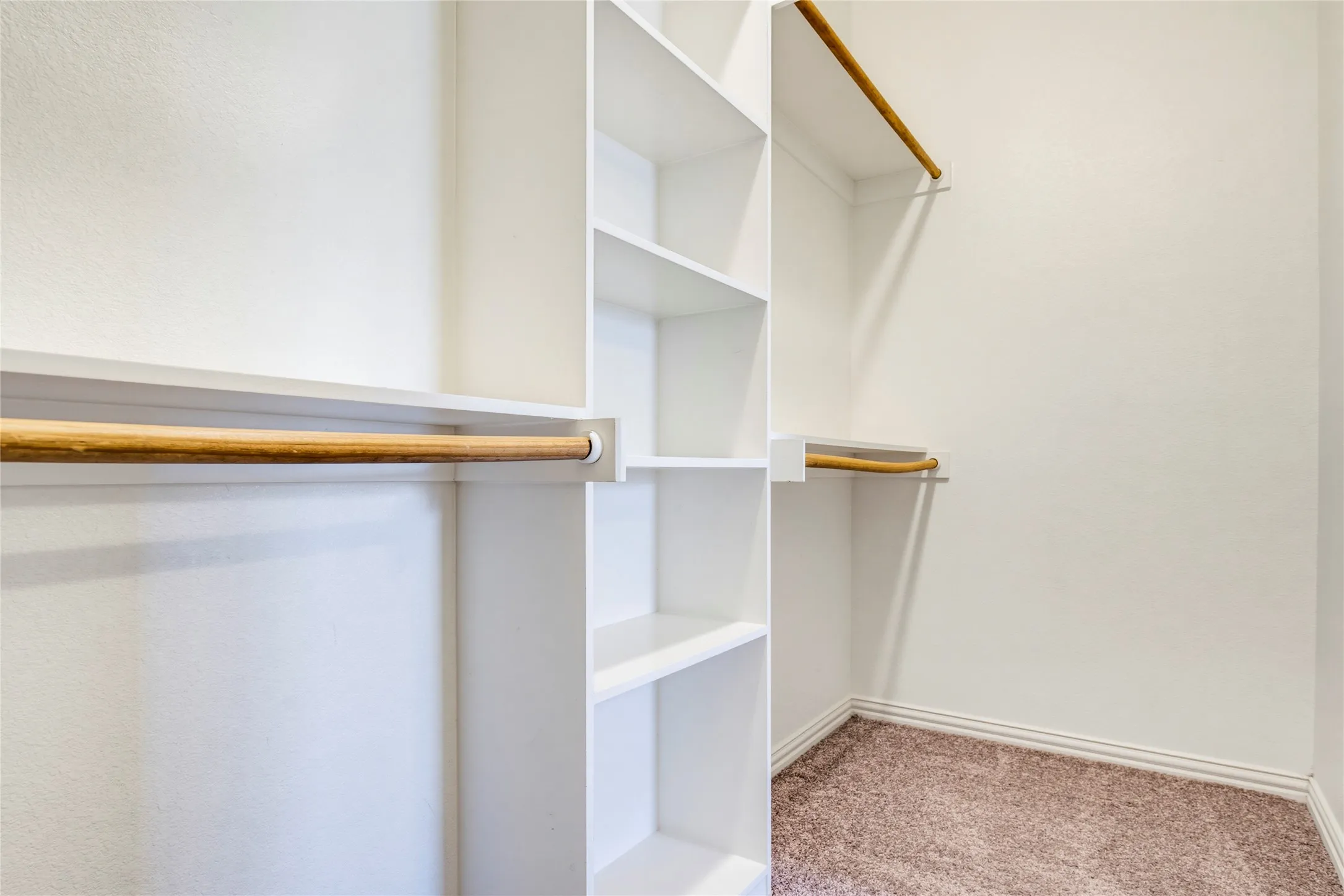 Built-in closet system featuring multiple shelves and hanging rods