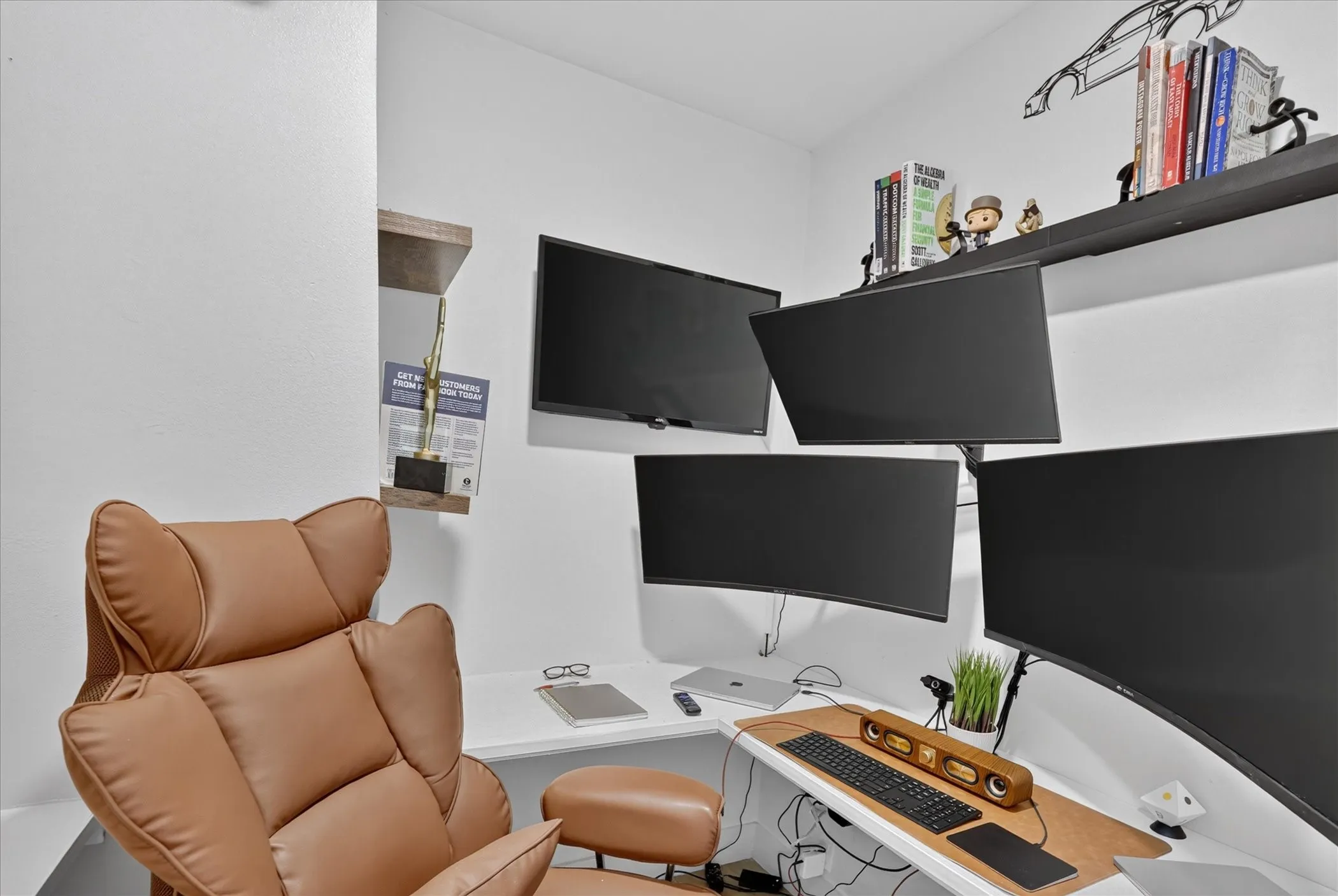 Built-in corner desk, wall-mounted monitors, and floating shelves