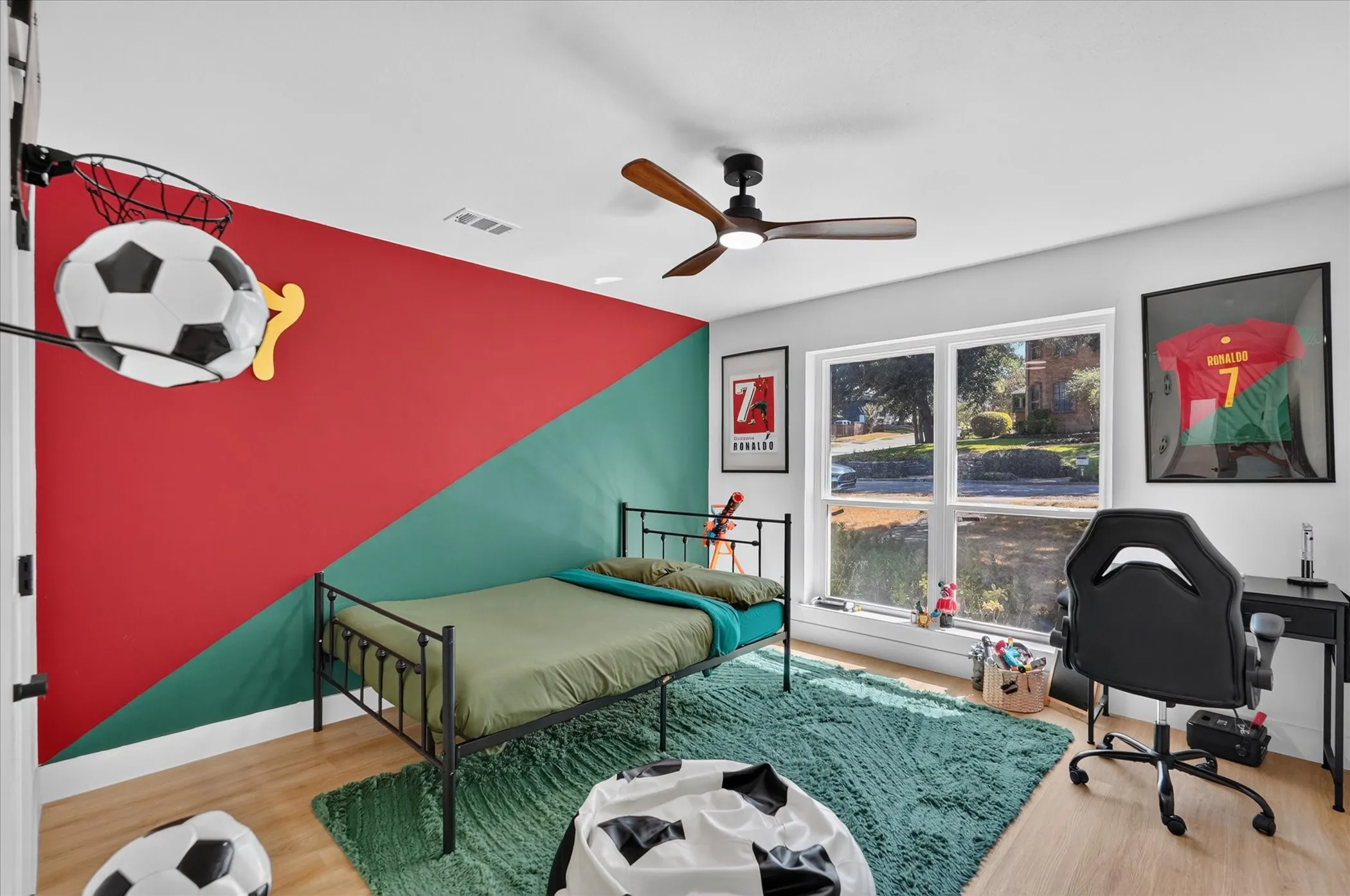 Wood-finish flooring with a ceiling fan featuring integrated lighting