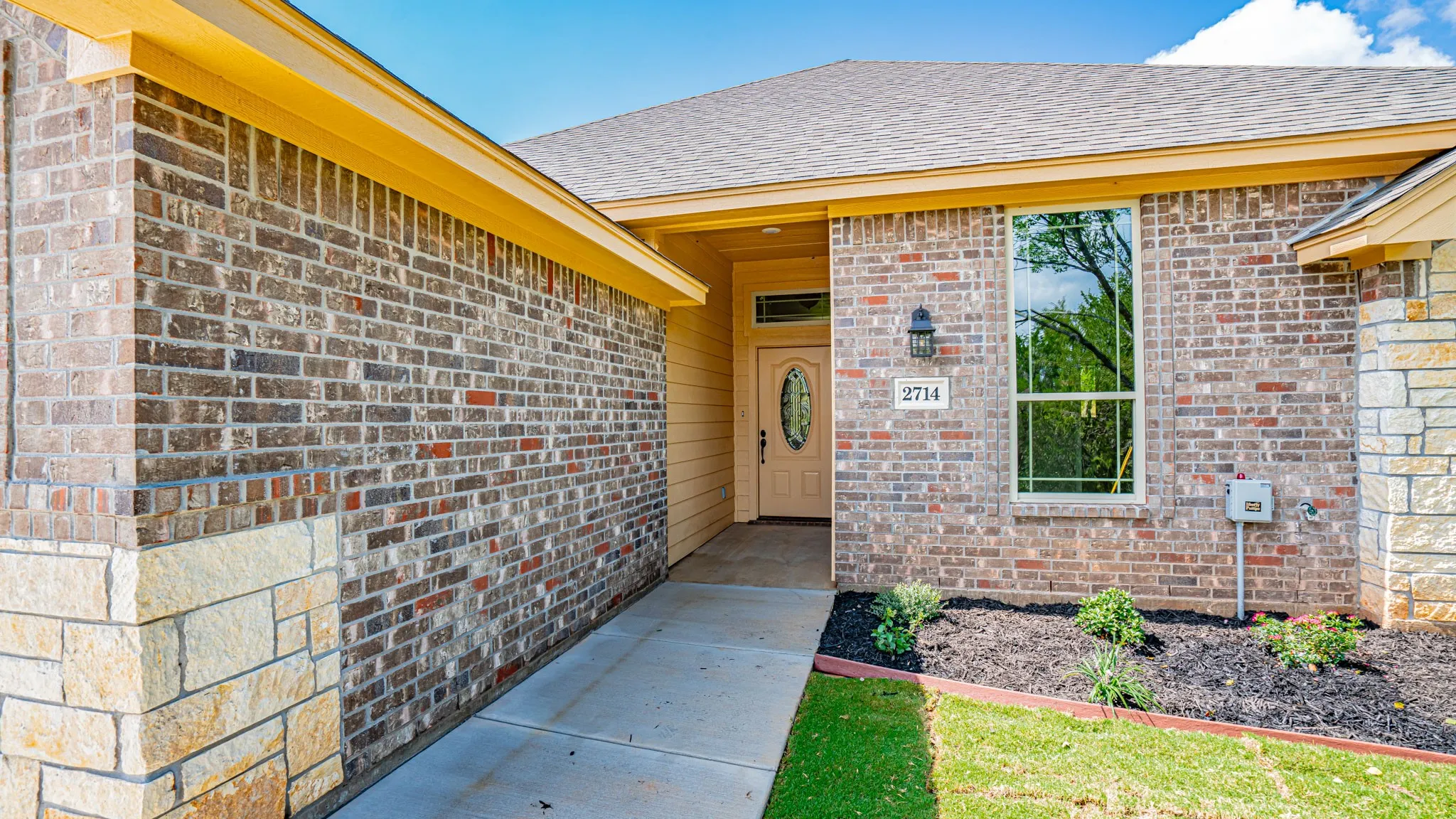 Front entrance of home with landscaped flowerbeds