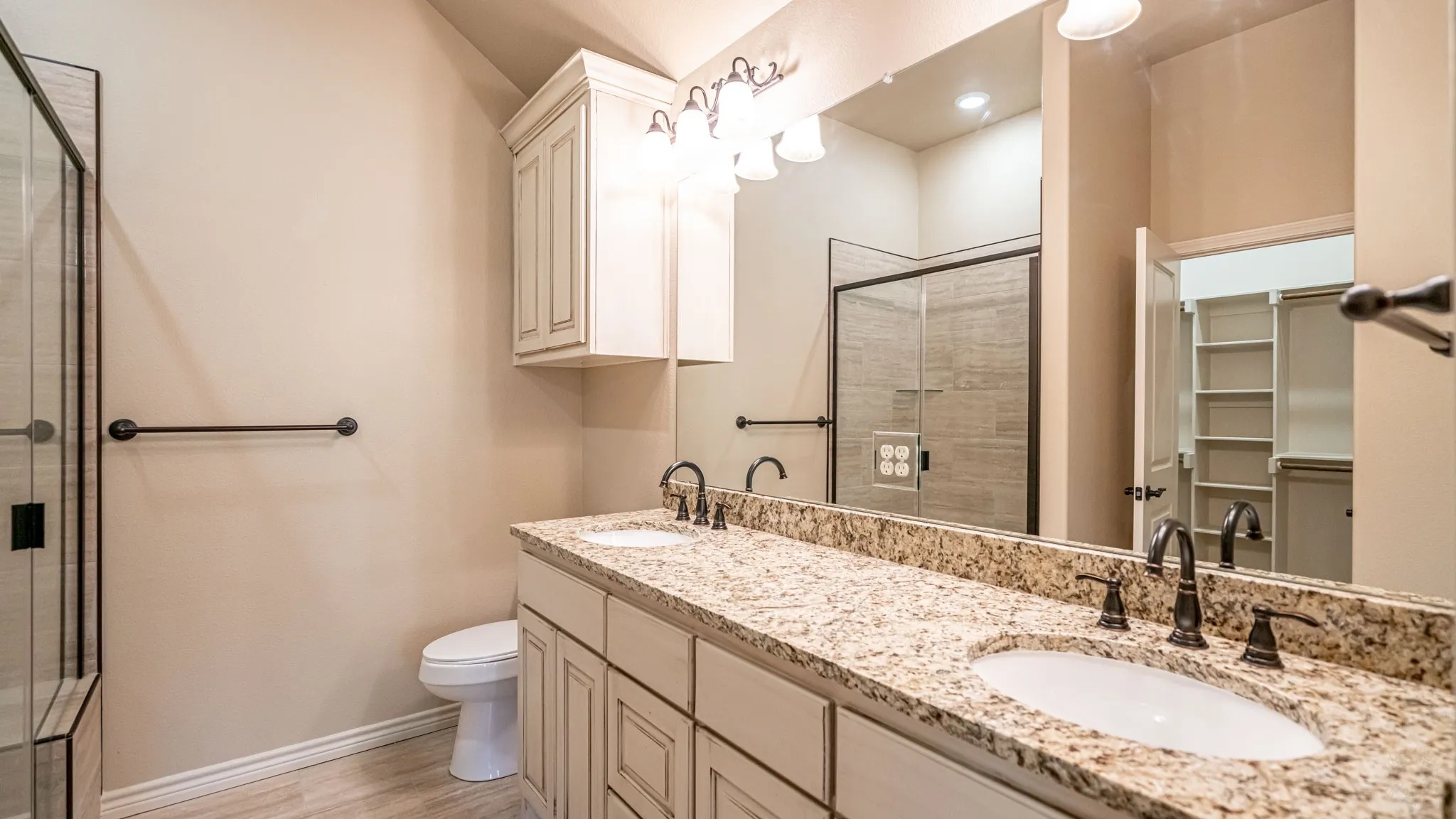 Primary bathroom with dual sinks and walk in shower