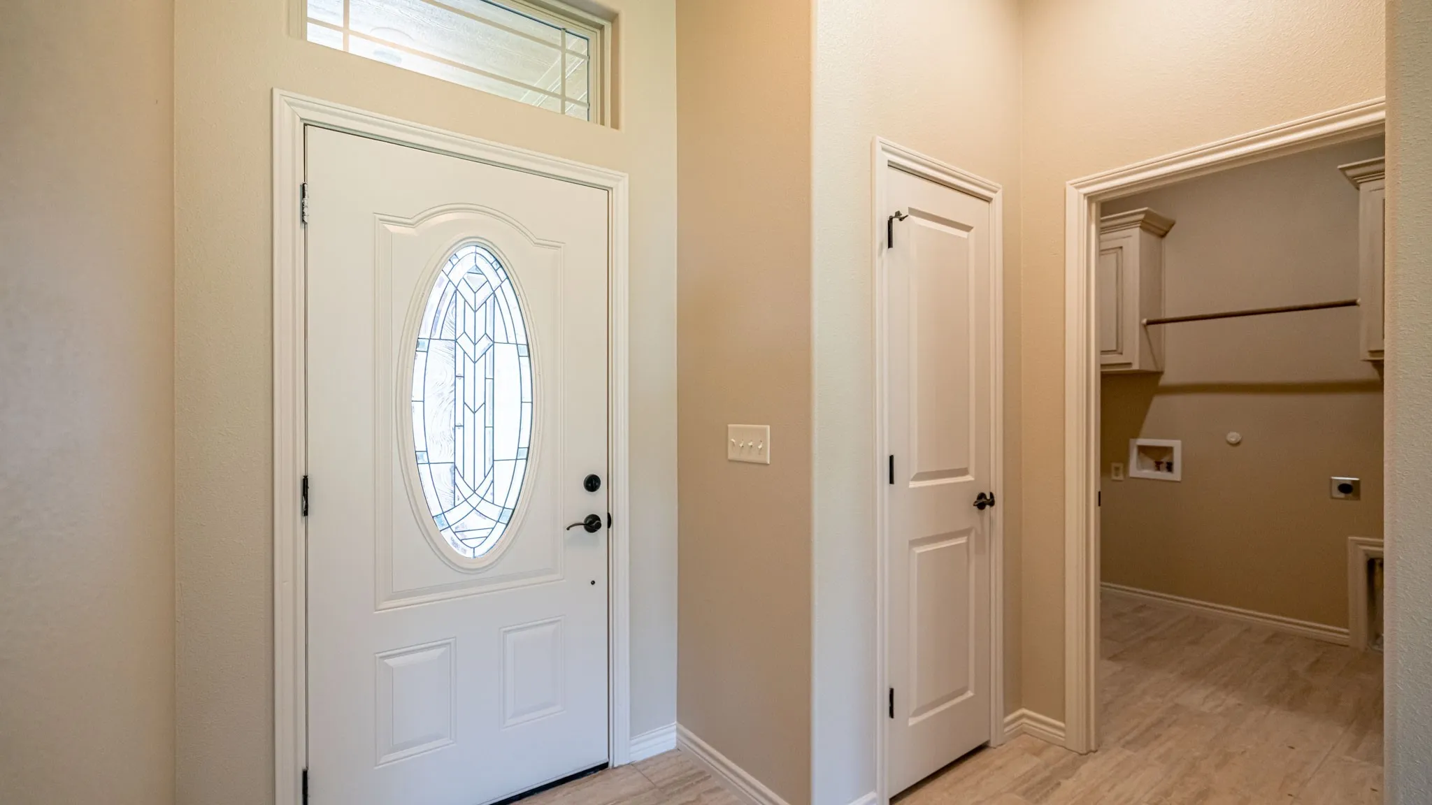 Front entrance with coat closet and access to laundry room