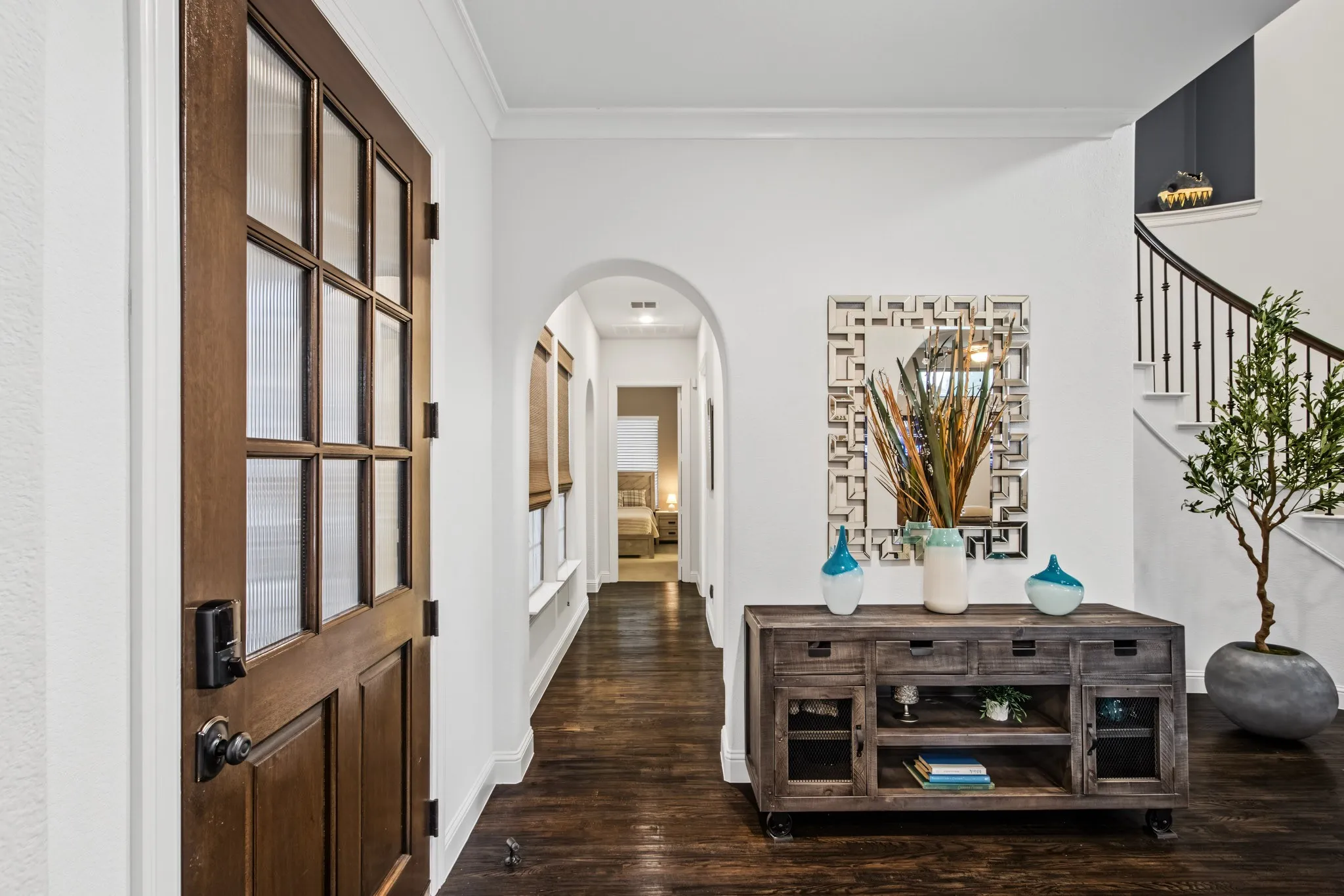 Foyer with arched hallway door leading to Guest suite.