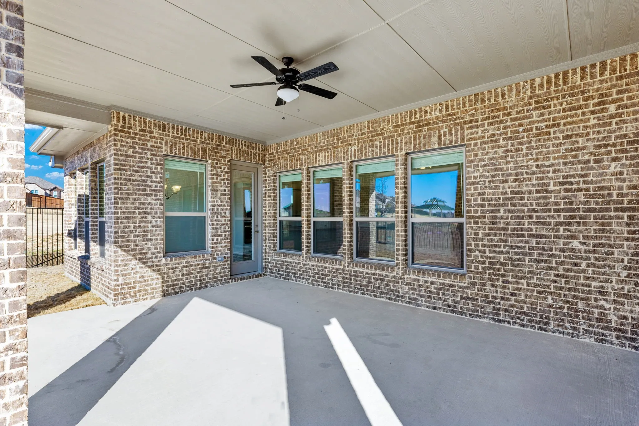 The covered patio comes complete with a ceiling fan for year round enjoyment.