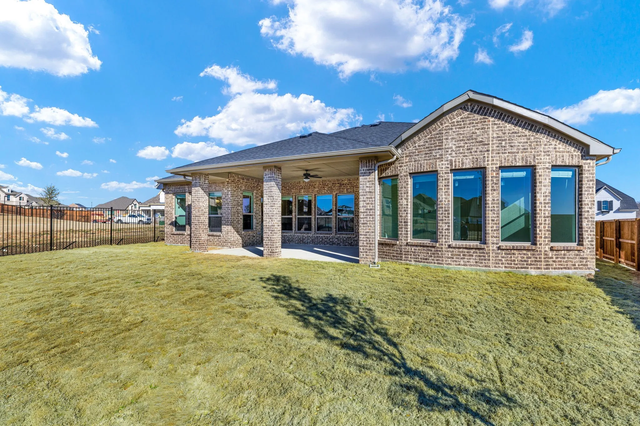 A view of the covered patio and spacious backyard.