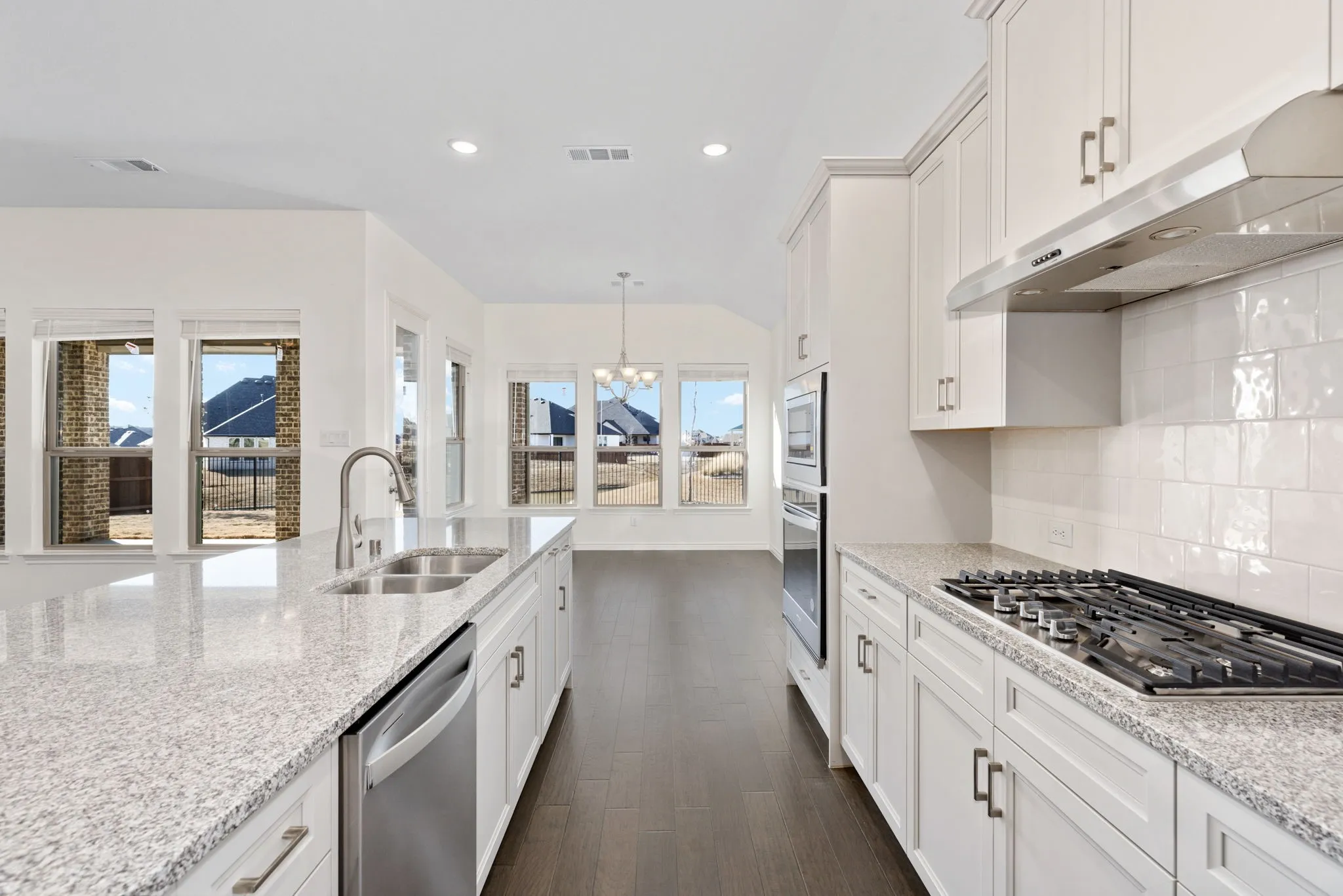 Featuring a wall of windows overlooking the backyard, 5013 Long Pond Trail boasts a spacious family room that opens to the kitchen.