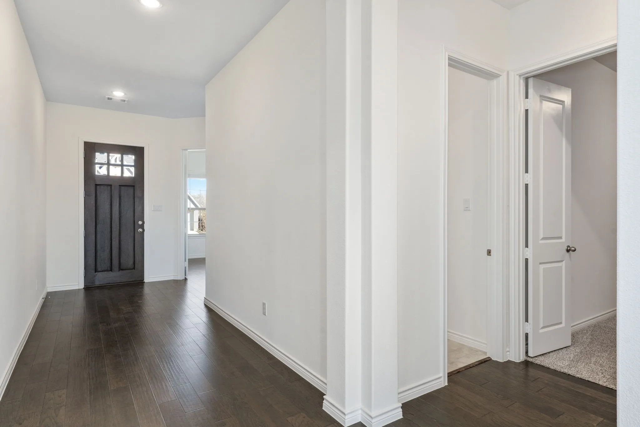 A spacious, light-filled entryway greets you as you enter this gorgeous home.