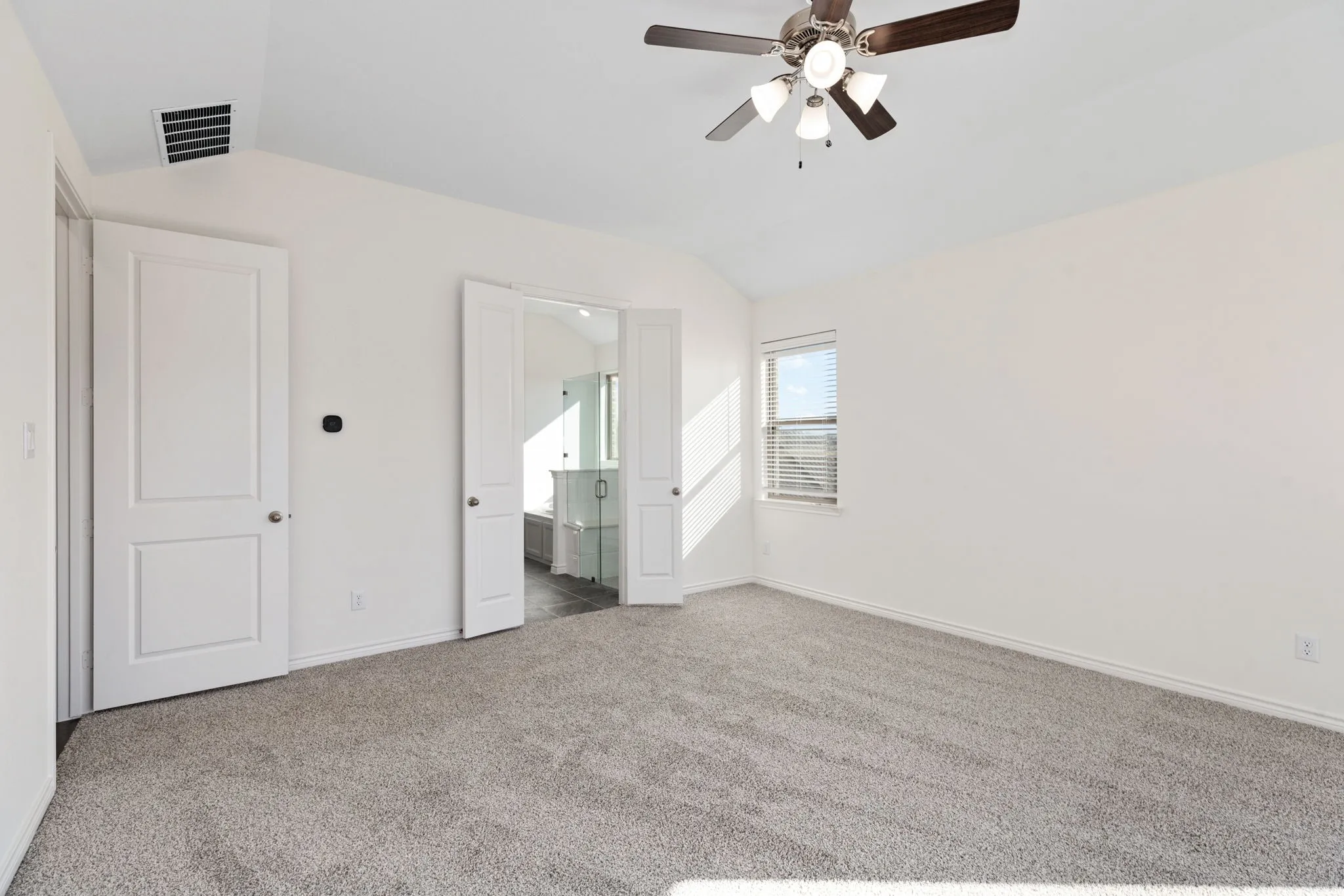 French doors lead from the primary retreat to the primary bath.