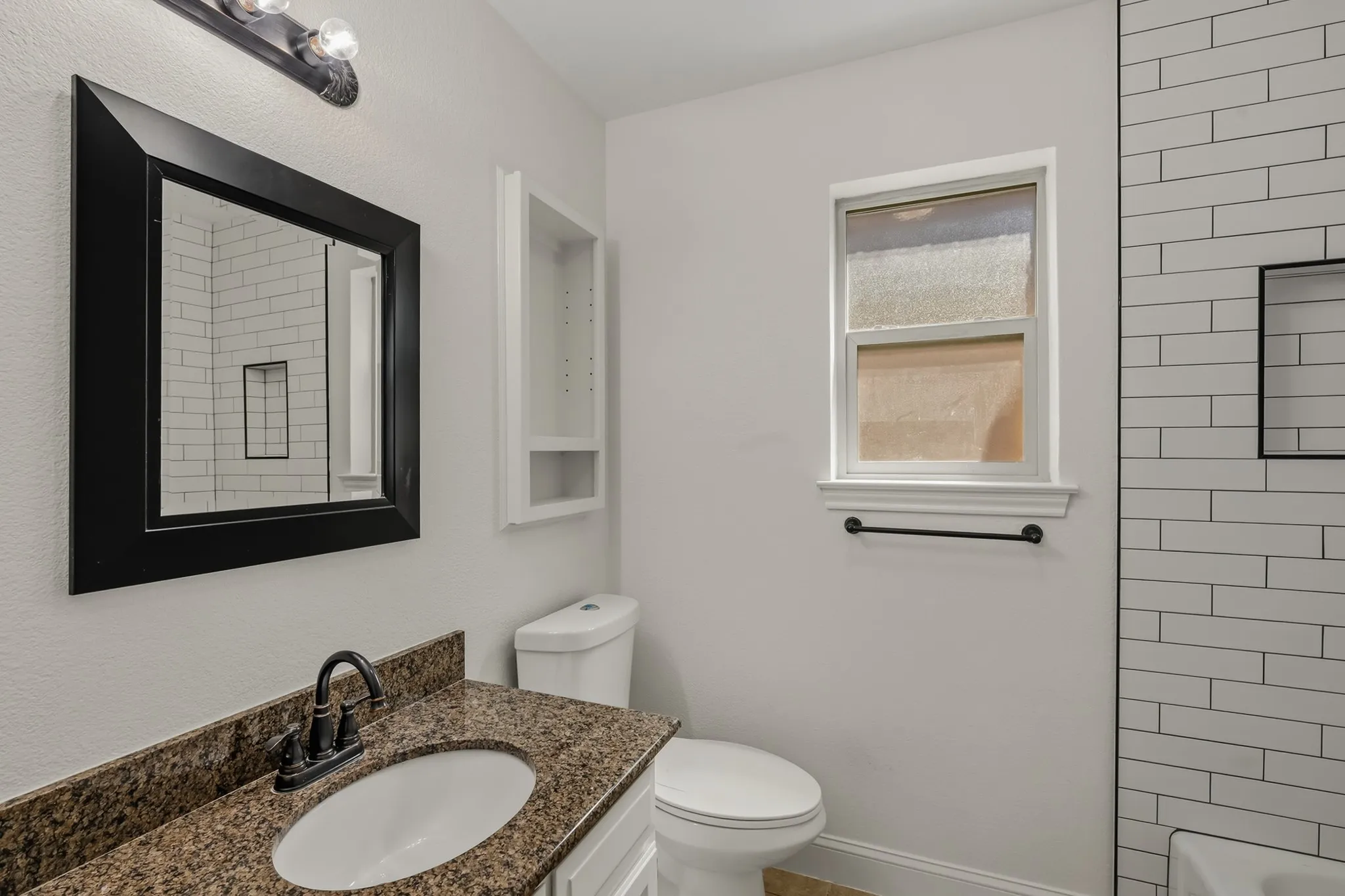 Secondary bathroom with bathtub shower combo.