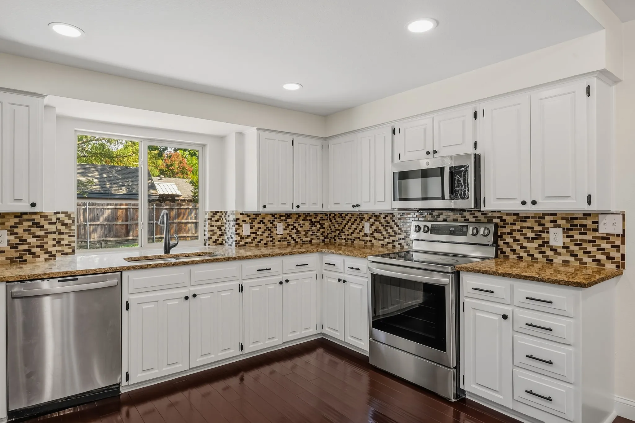 Kitchen features an abundance of storage cabinets and drawers.