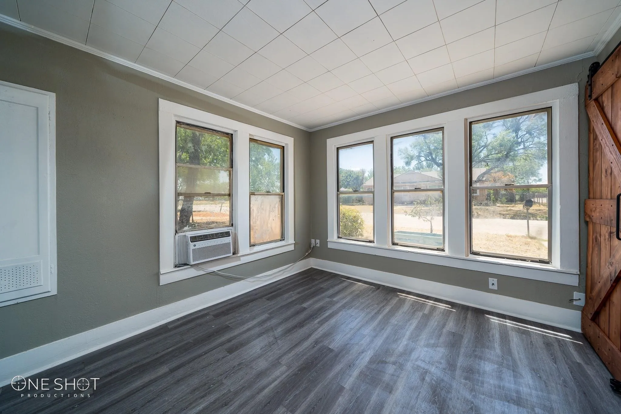 Unfurnished room with cooling unit, dark hardwood / wood-style flooring, and a wealth of natural light