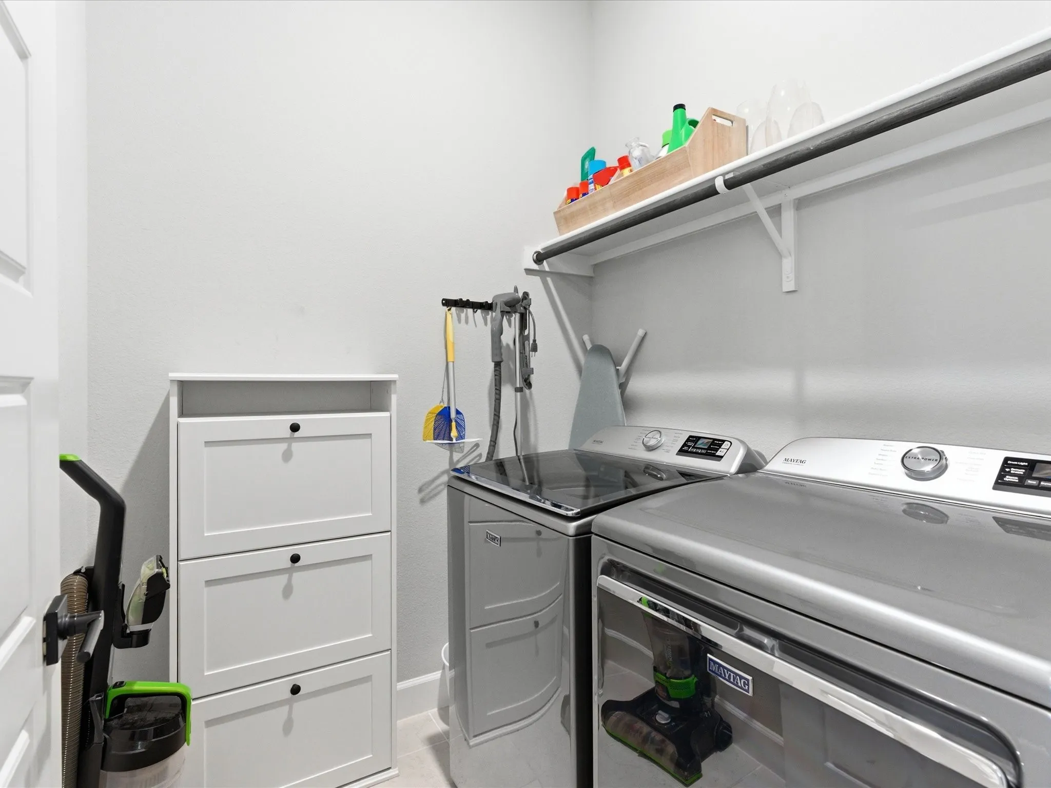 clean and functional laundry room with a well-organized layout, offering a convenient space to handle everyday laundry with ease