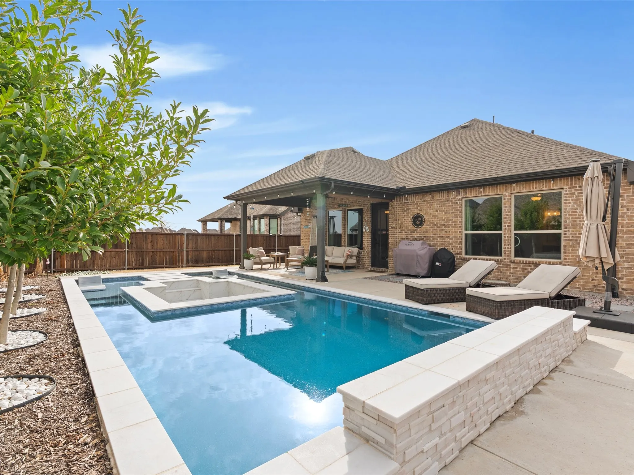 spacious backyard featuring a sparkling swimming pool, creating the perfect outdoor retreat for relaxing, entertaining, and enjoying sunny days at home
