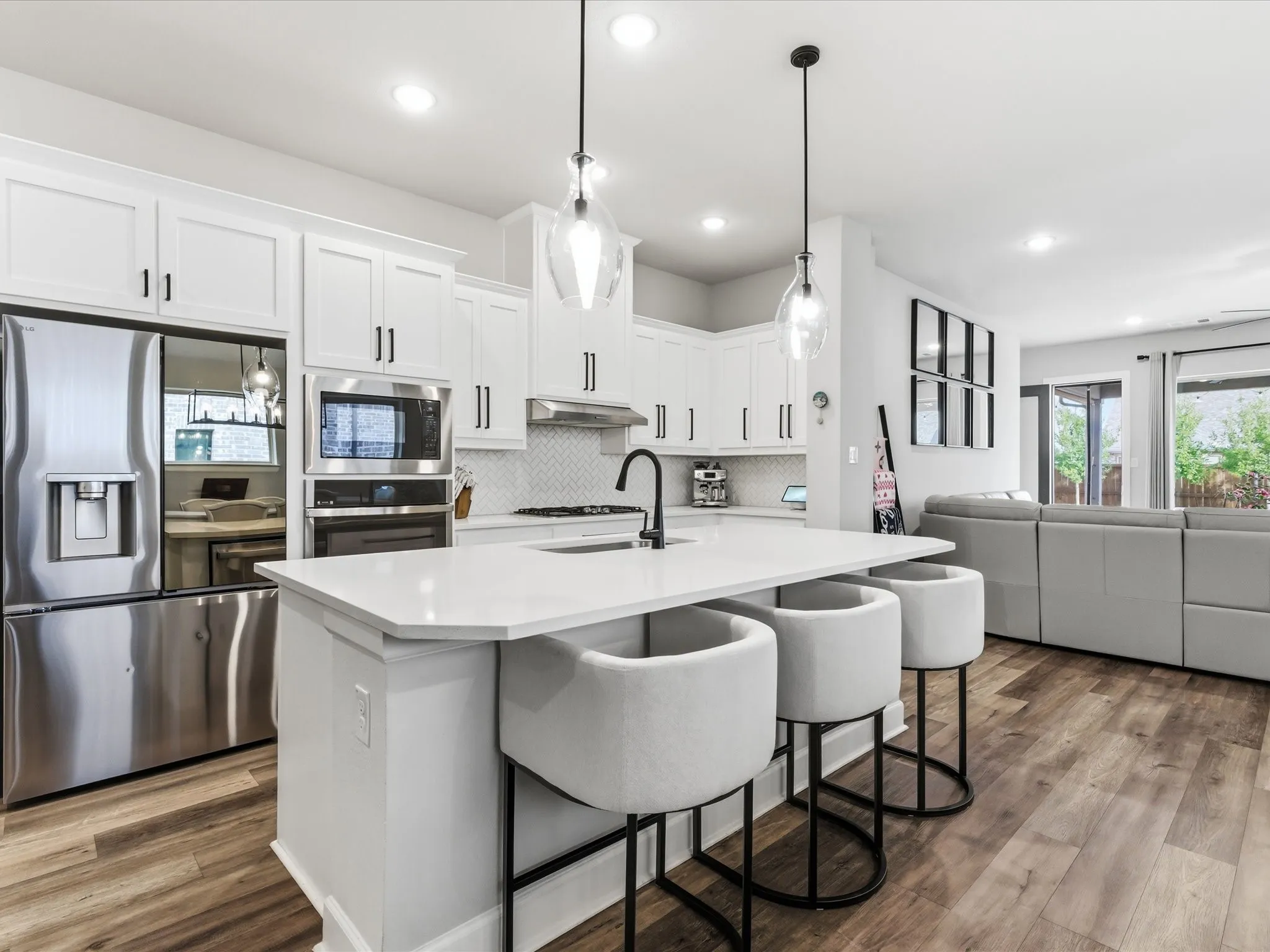 spacious kitchen featuring a large center island and modern appliances, creating a functional and inviting space for cooking, gathering, and entertaining