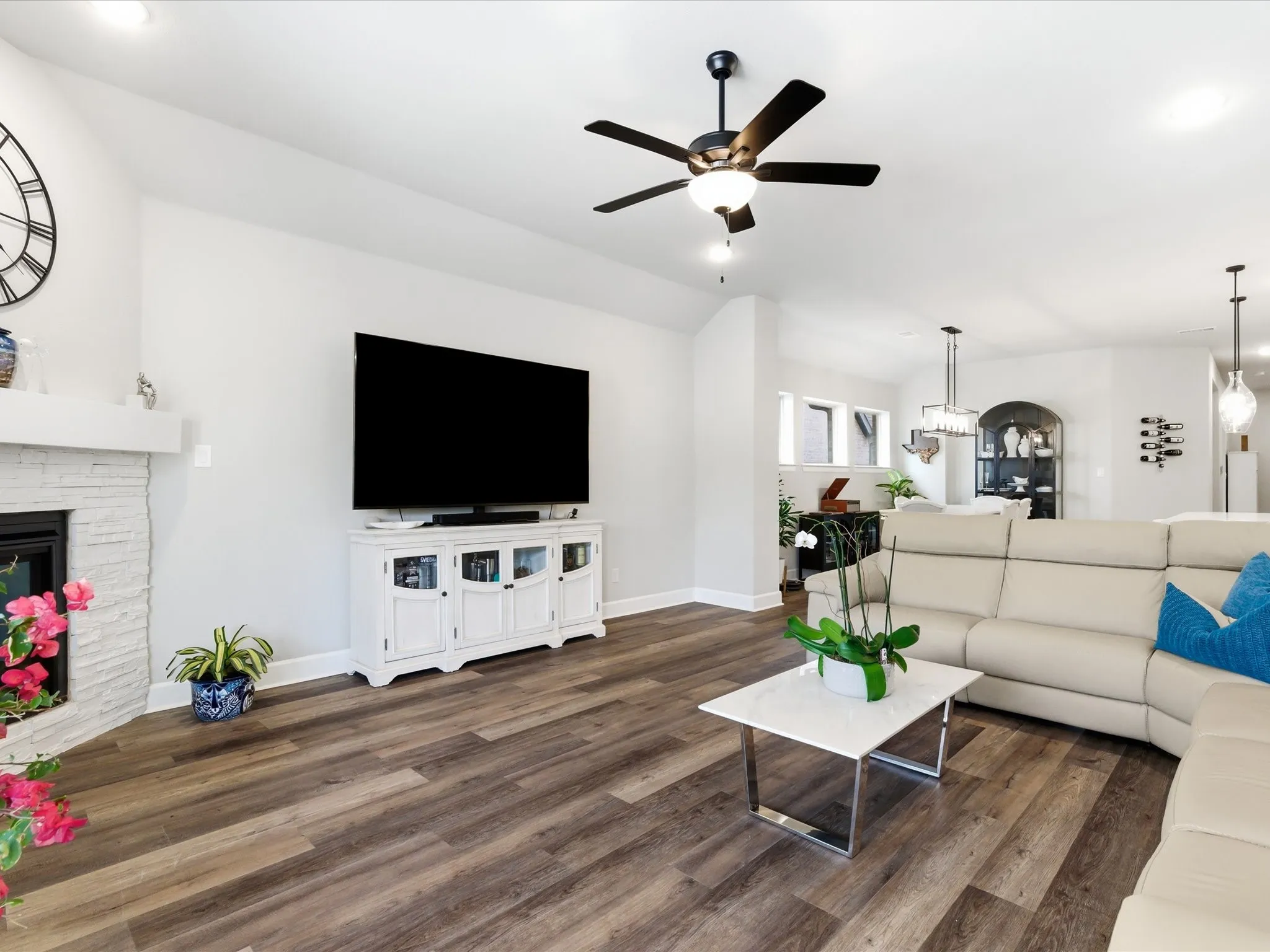 inviting living room centered around a large TV, creating the perfect entertainment space for movie nights, relaxing evenings, and gathering with family and friends
